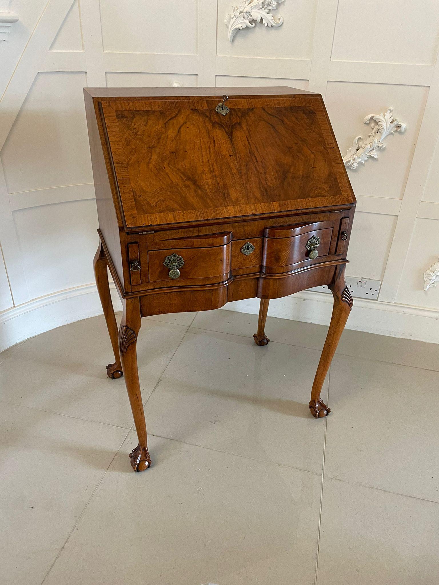 Antique quality burr walnut bureau having a quality burr walnut top above a burr walnut crossbanded fall opening to reveal a fitted interior consisting of a centre drawer flanked by pigeon holes above one long serpentine shaped burr walnut drawer
