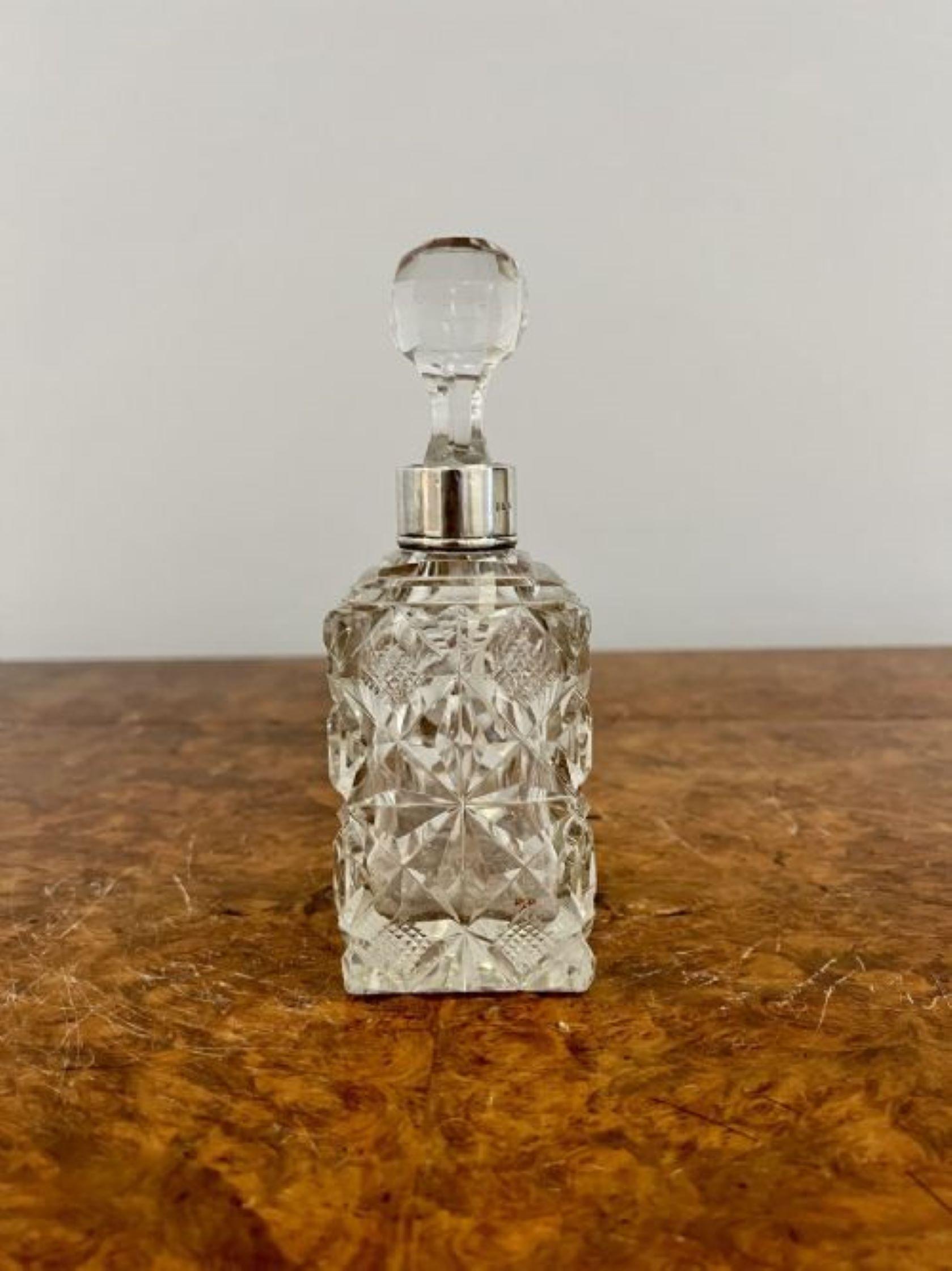 Antique quality cut glass decanter with the original stopper and a silver plated collar
