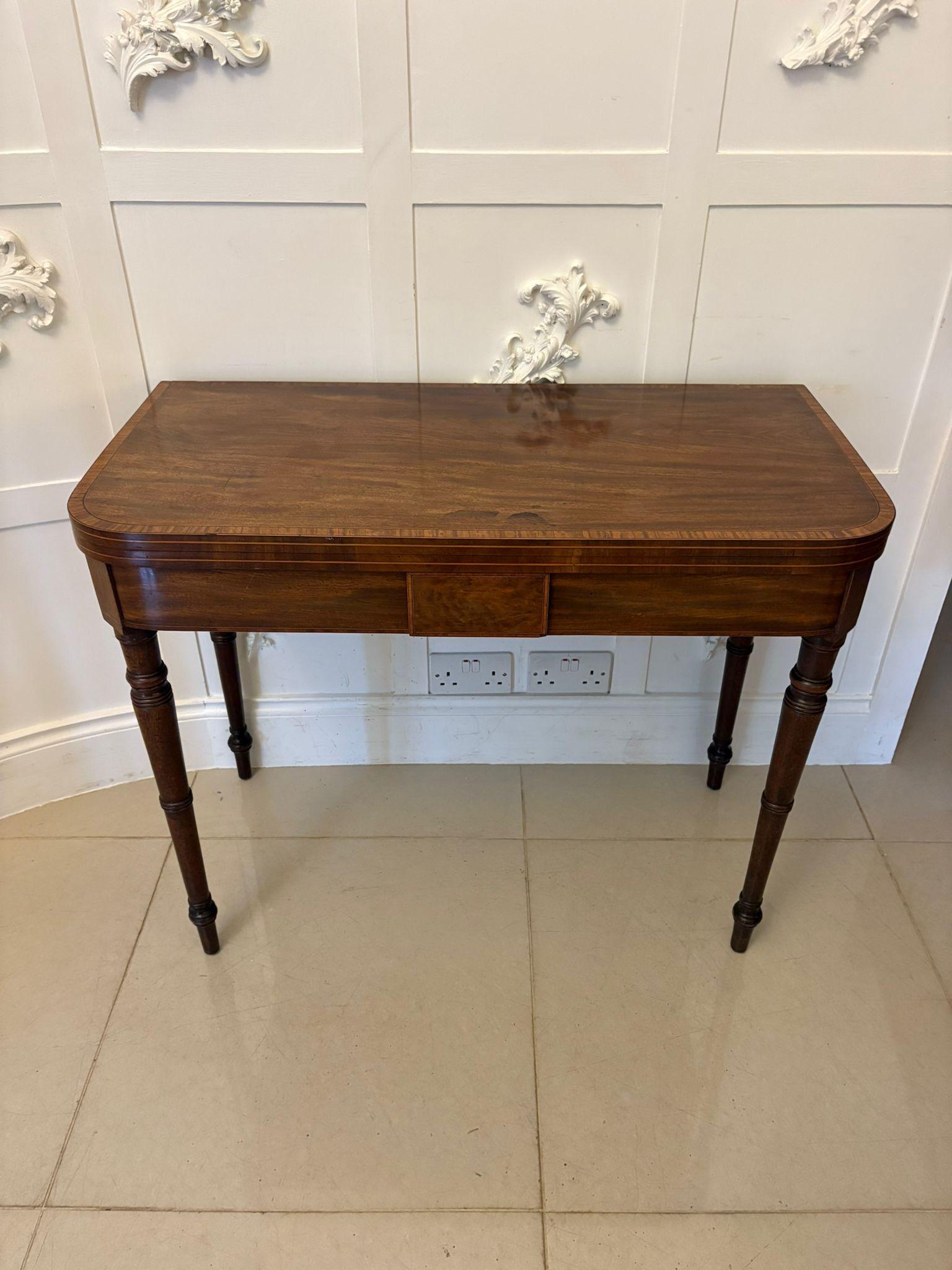 A superb and highly refined George III mahogany fold-over card table distinguished by its beautifully figured top framed with finely executed satinwood crossbanding and delicate ebony stringing. The craftsmanship is elegant and restrained, with a
