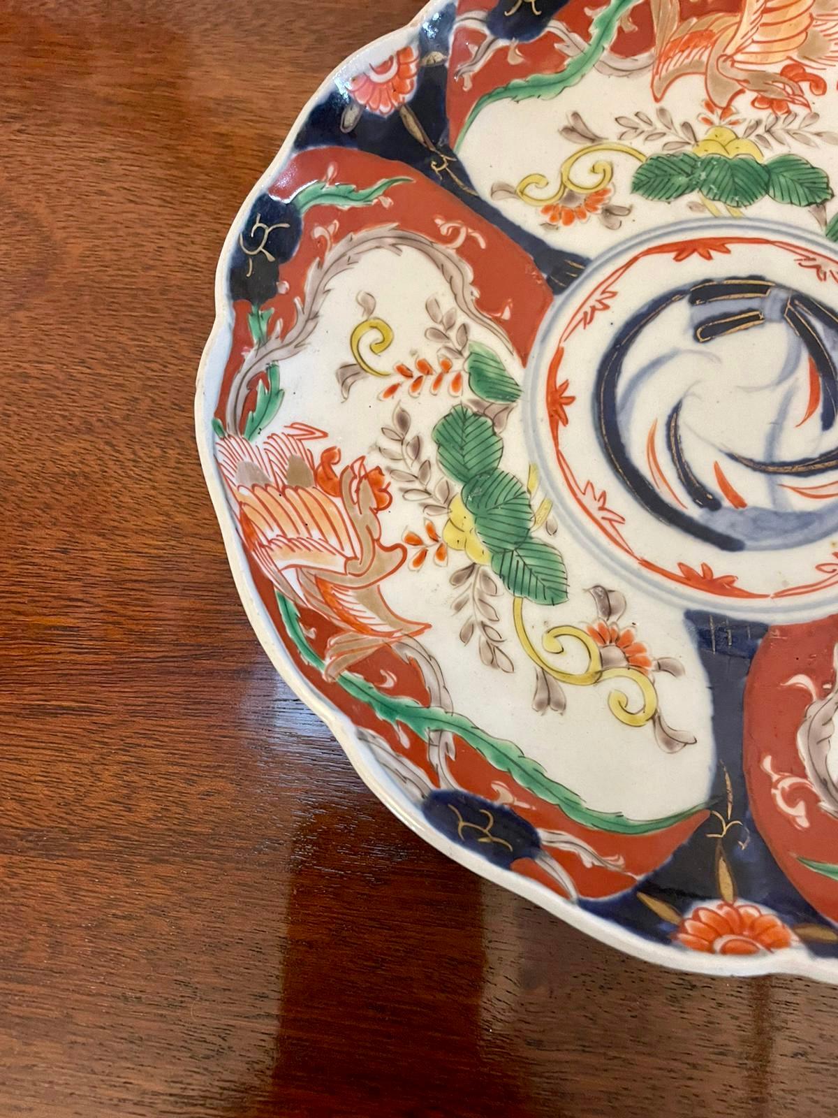 Antique quality Japanese Imari plate having a scalloped shaped edge and boasting wonderful hand painted panels in red, blue, white, yellow, green and gold colours 


In perfect original condition


Dimensions:
Height 3.5 cm 
Width 22 cm 
Depth 22