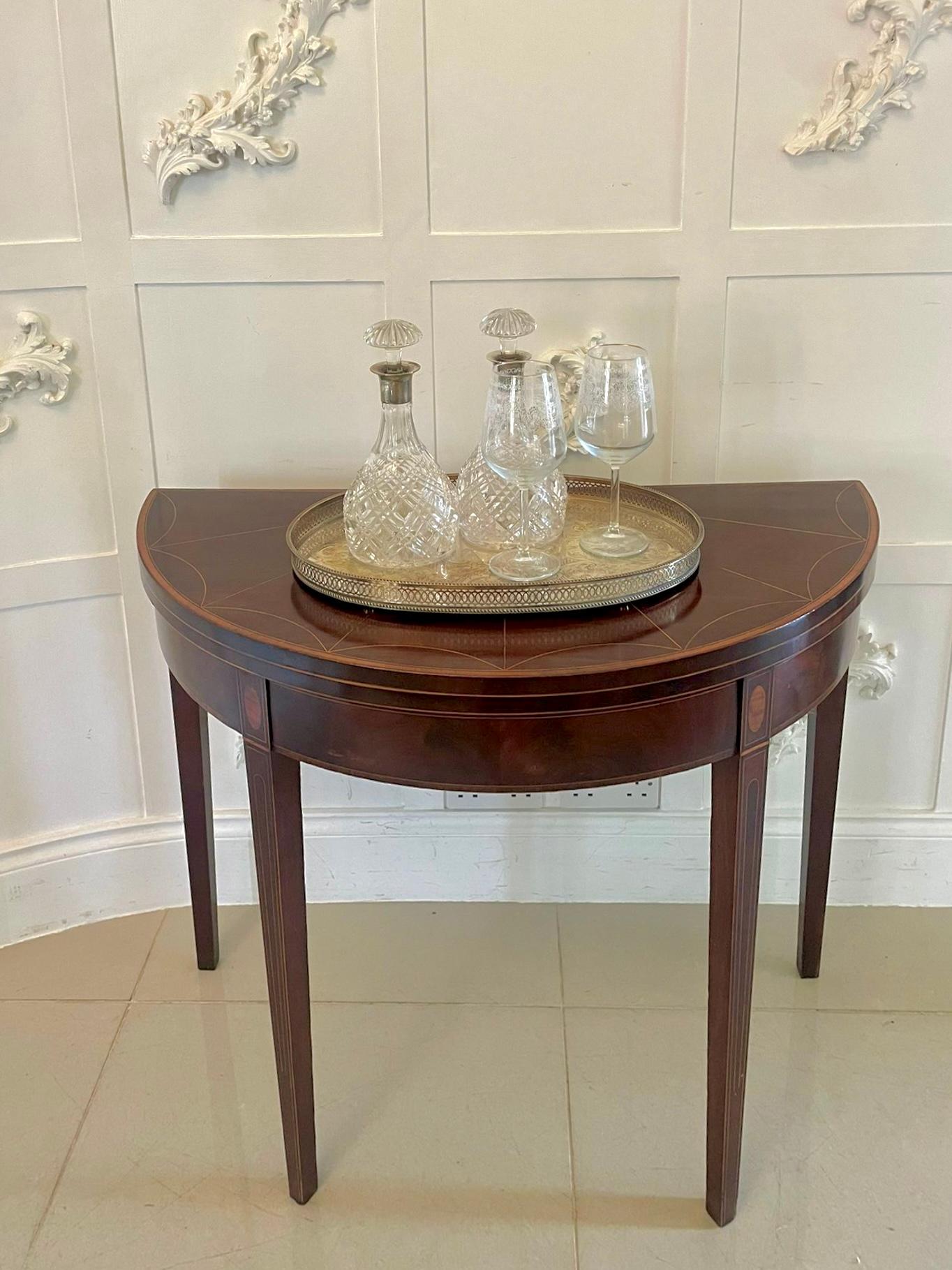 Table à cartes de forme demi-lune en acajou et bois de satin incrusté, de belle qualité, de style George IIl
avec un couvercle rabattable en acajou figuré de forme Demi lune avec incrustation en bois de satin de qualité s'ouvrant pour révéler un