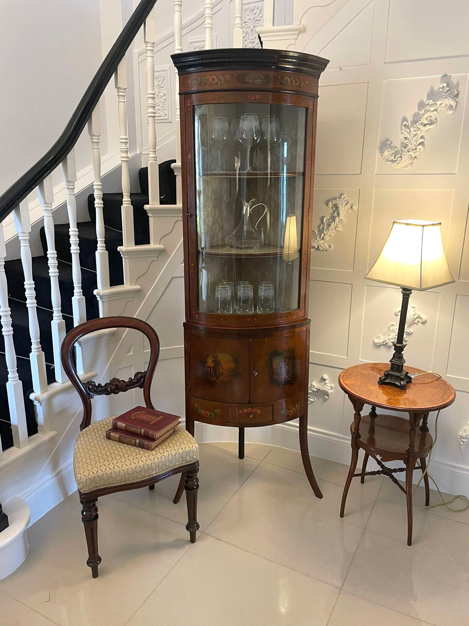 Antique Victorian quality mahogany and painted decorated bow fronted corner display cabinet having a moulded cornice above a quality painted frieze above a single glazed bow fronted door opening to reveal two fitted shelves. The pair of painted