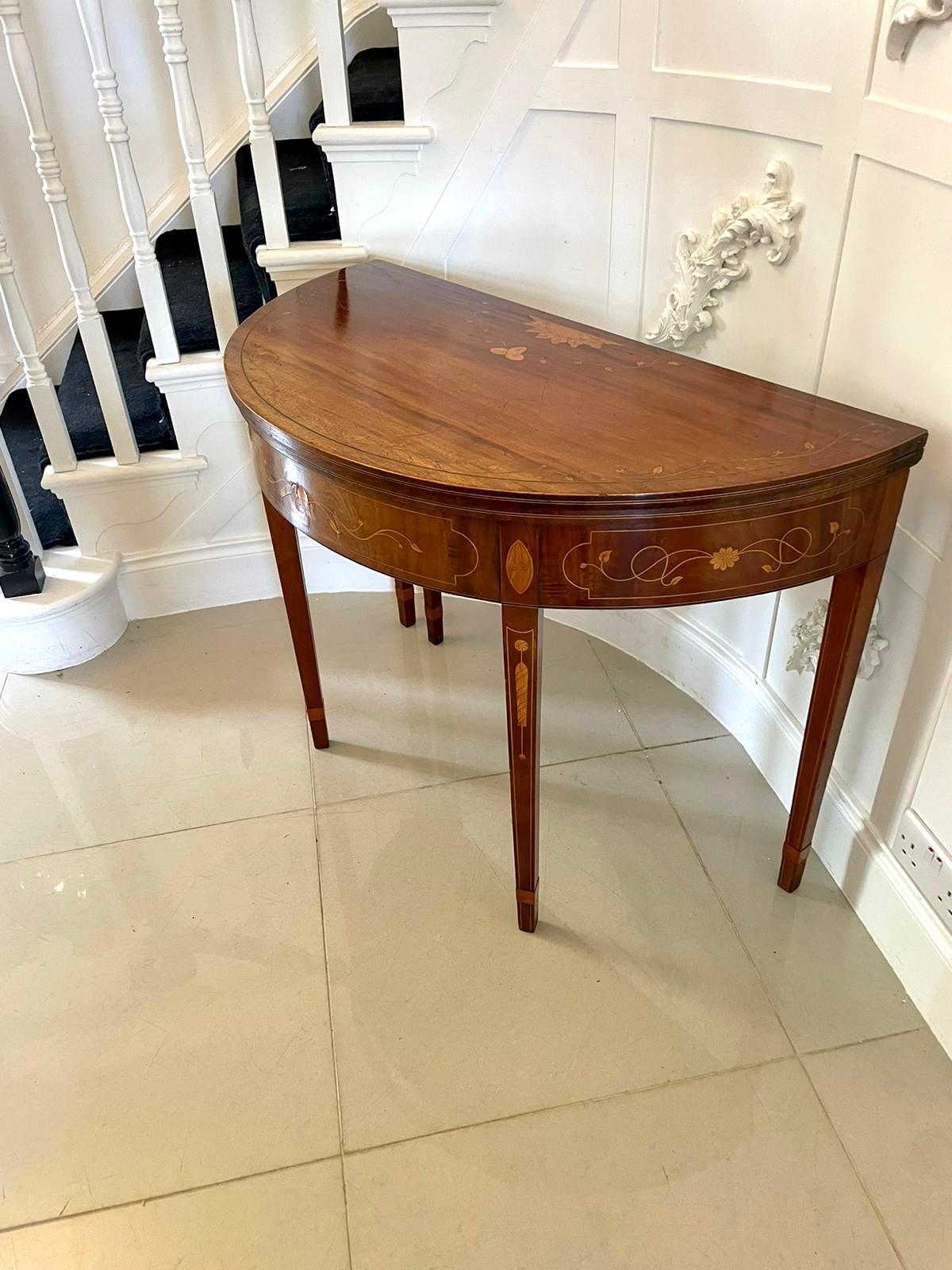Antique George III quality mahogany and satinwood inlaid demi lune shaped card/console table 
having a quality mahogany and satinwood inlaid demi lune shaped fold over top opening to reveal the original green baize interior, pretty inlaid freeze