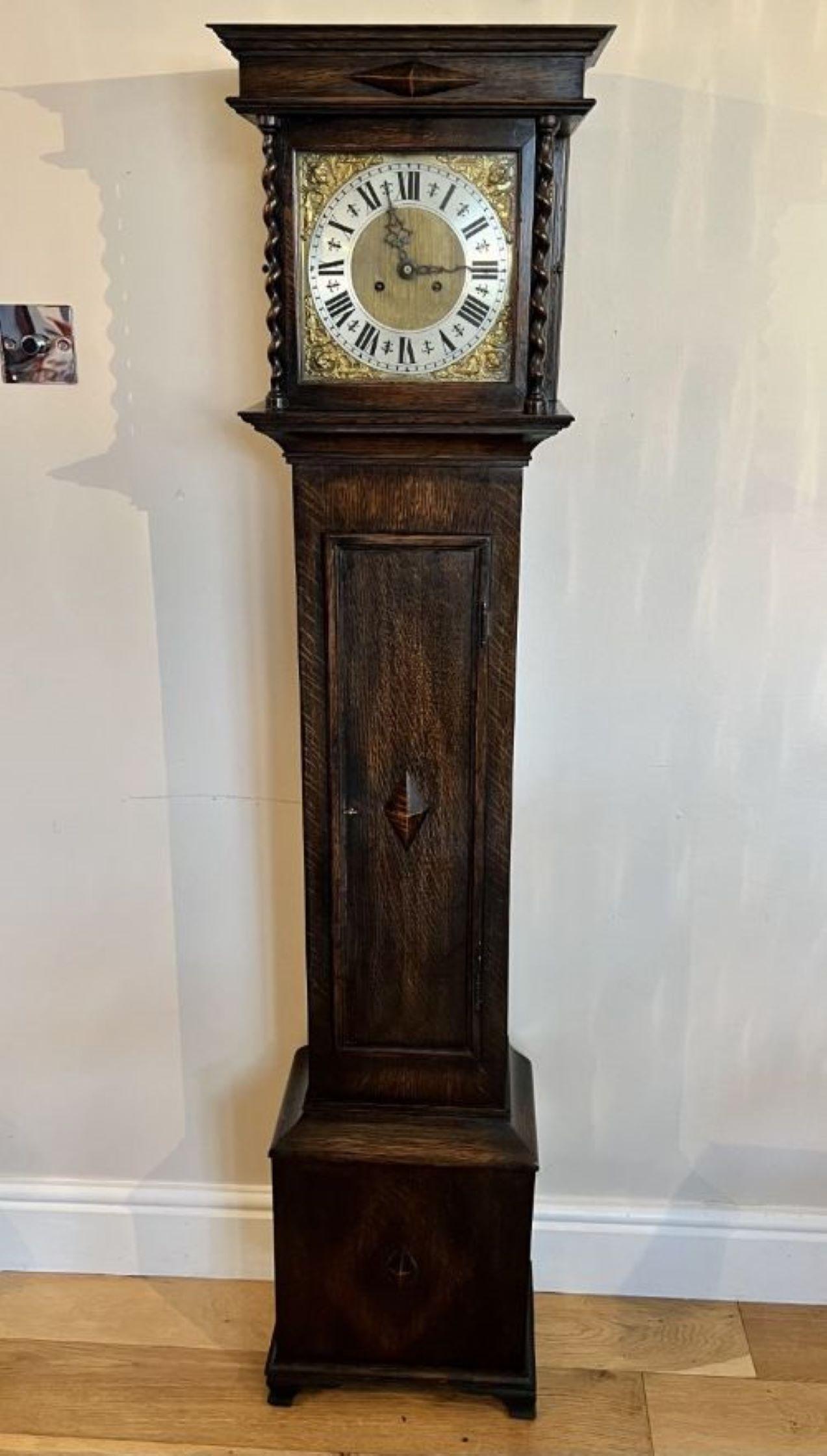 Antique quality oak brass face grandmother clock having a quality brass dial silvered chapter ring with Roman numerals, original hands, eight day movement striking the hour and half hour on a gong, barley twist supports to the glass door, long oak