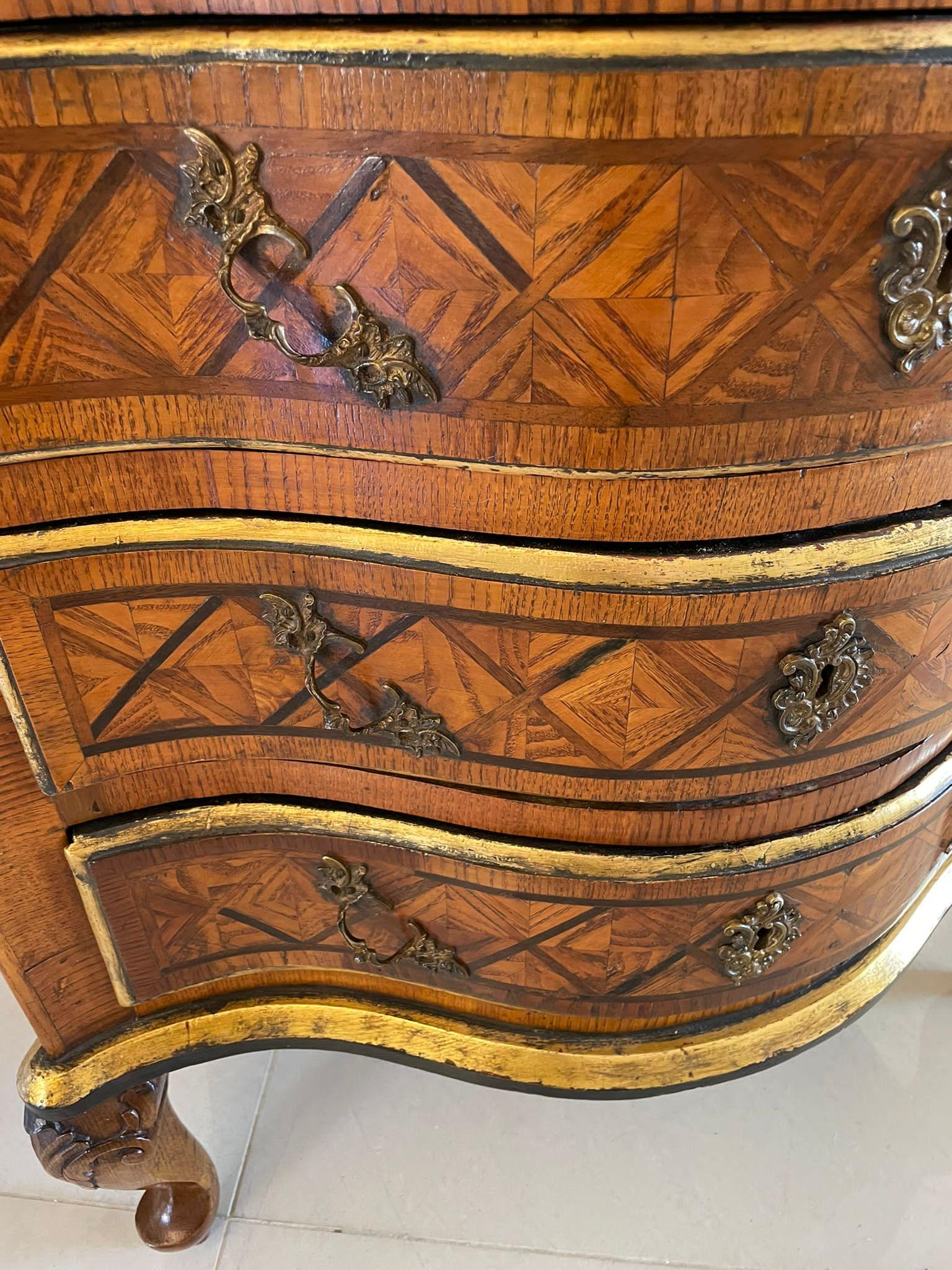 Antique 18th century quality parquetry inlaid serpentine shaped marble top commode chest having a wonderful serpentine shaped coloured marble top, gilded frieze above three serpentine shaped parquetry inlaid drawers with original brass handles and