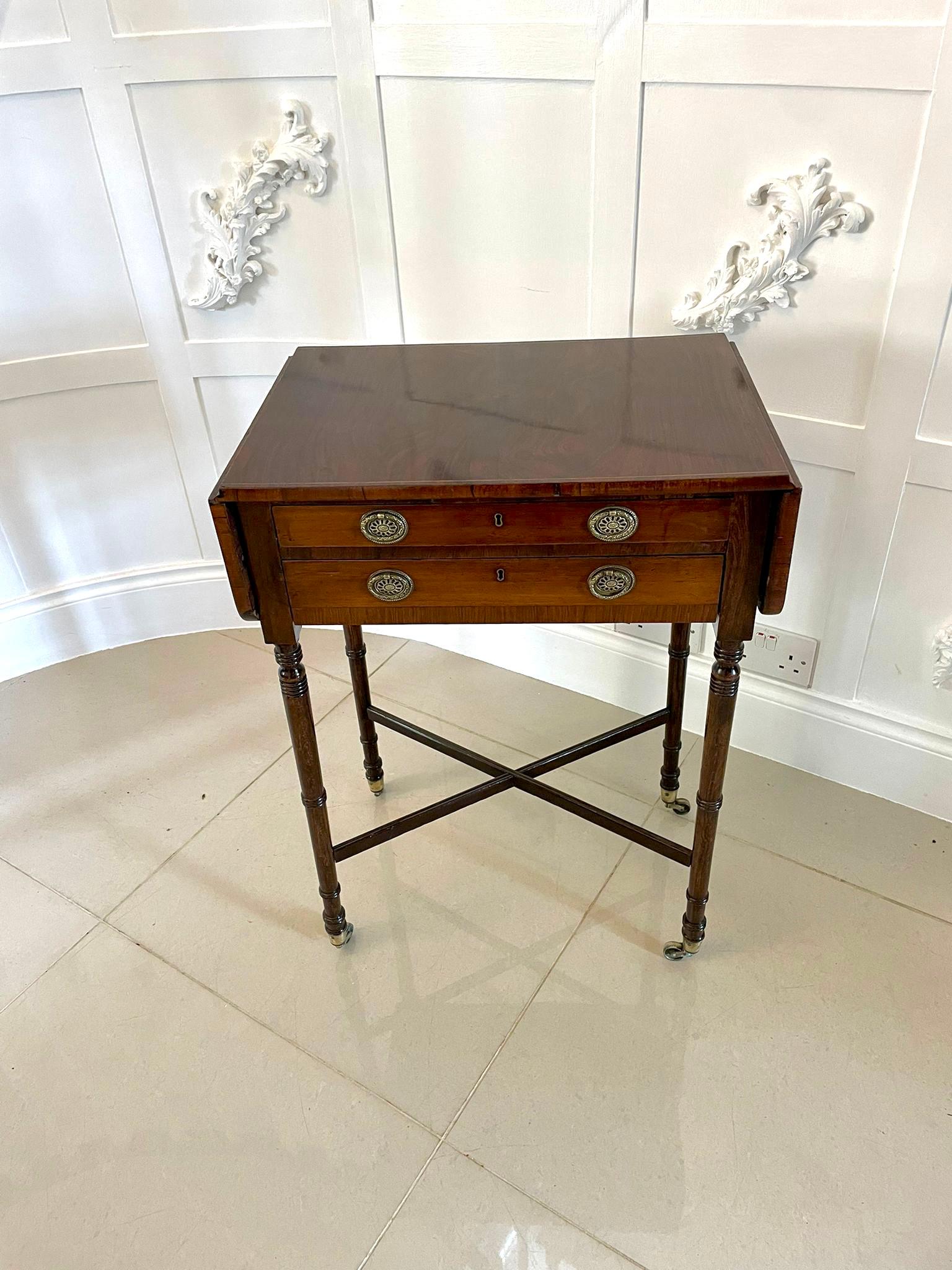 Antique Regency quality rosewood freestanding drop leaf lamp table having a quality rosewood top with two drop leaves and satinwood stringing, two drawers with original ornate oval brass handles containing the makers label Druce & Co. London,
