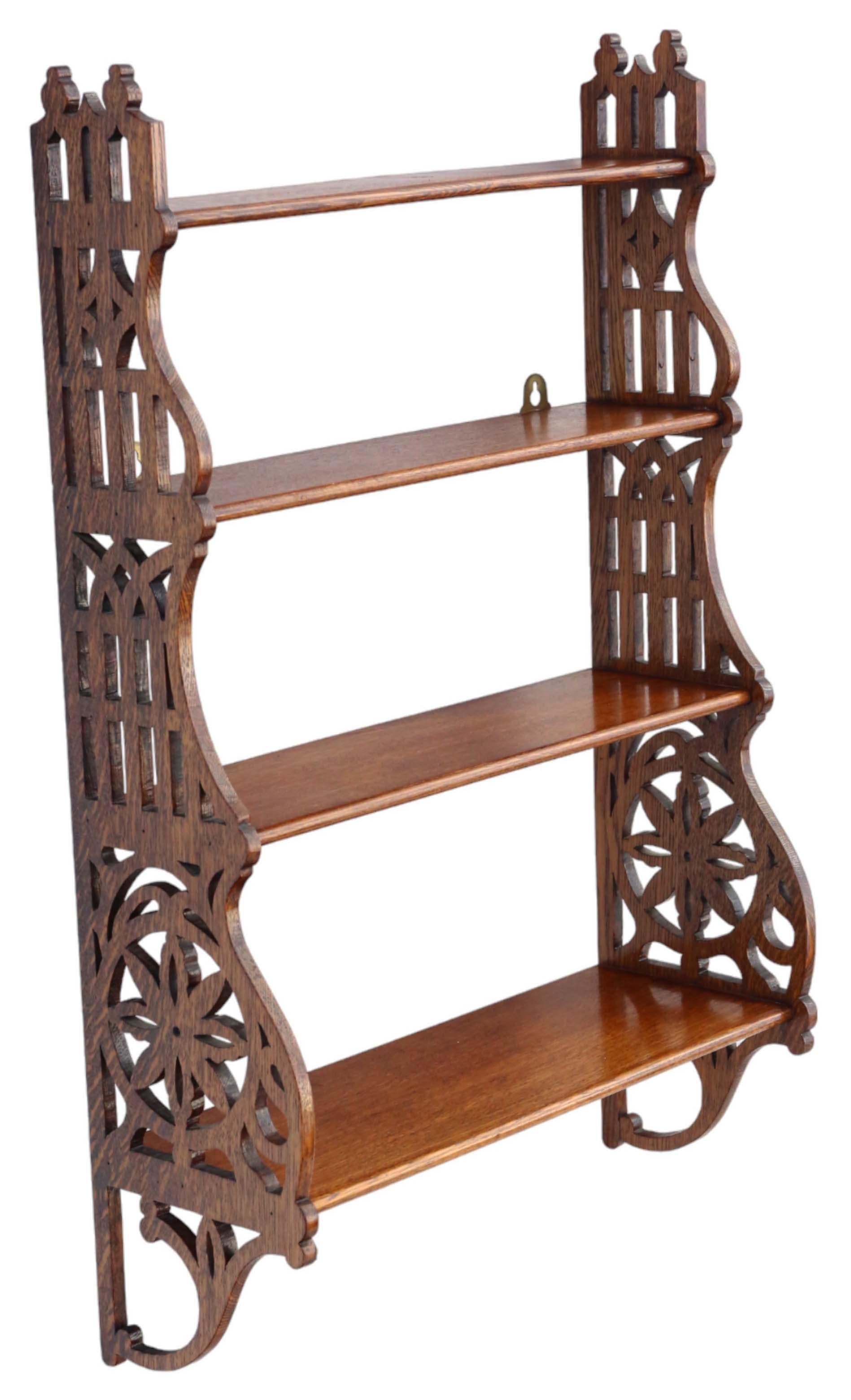 Antique Victorian Gothic circa 1900 fret-cut oak bookcase wall shelves of exceptional quality.

This piece exudes age, charm, and character, featuring a robust structure with no loose joints and no woodworm.

Its presence would be striking in the