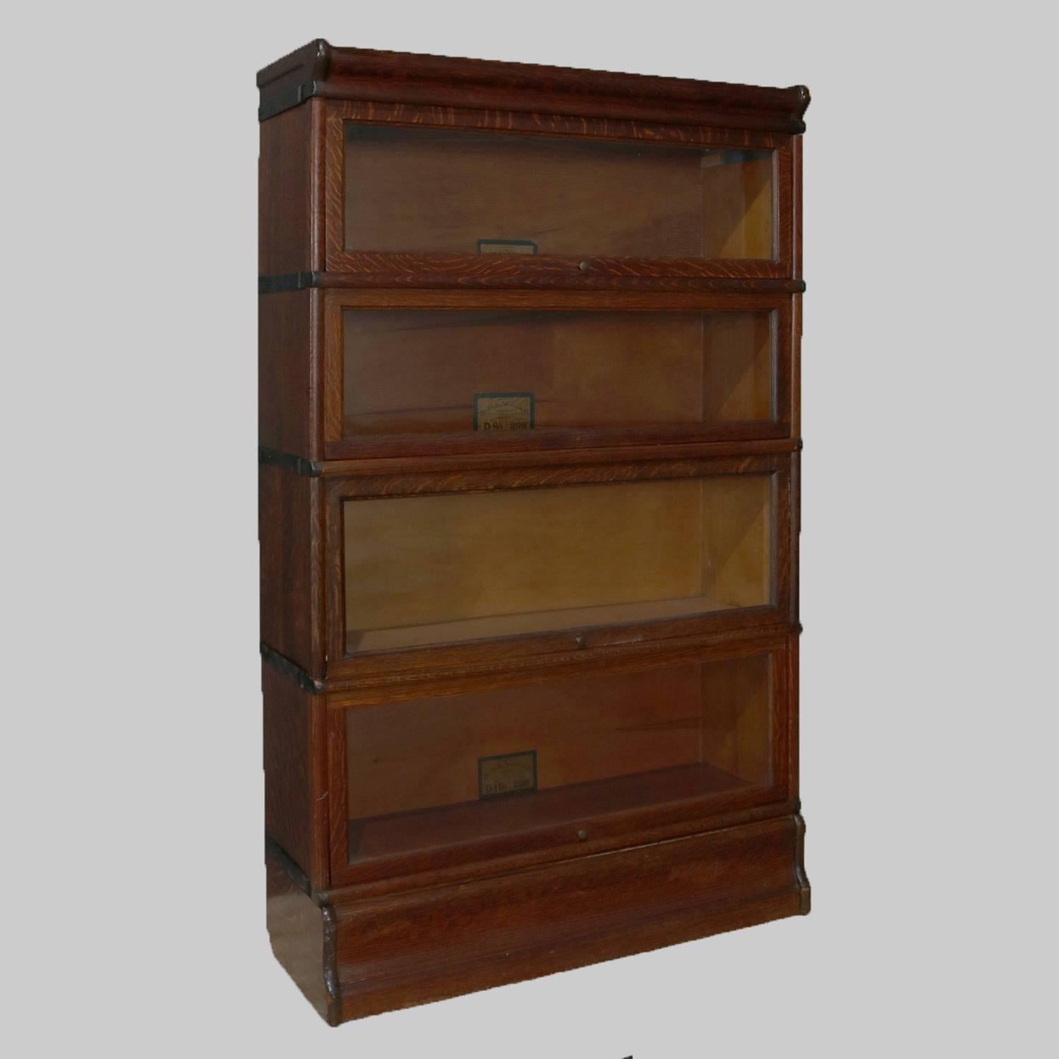 Antique Barrister bookcase by Globe-Wernicke Co. features quarter sawn oak construction with four stacks and pull-out glass doors, original labels, most frequently seen in the legal profession and law offices, circa 1910.

Measures - 56