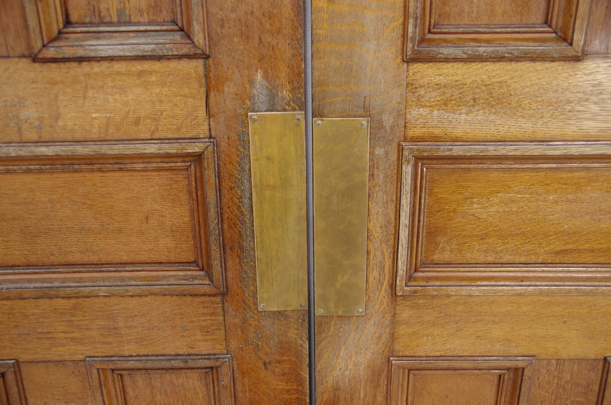 Pair of antique early 20th century quarter sawn oak doors with five panels each. Comes with spring hinges. Medium tone. This can be seen at our 400 Gilligan St location in Scranton, PA. Measures: 91.75 high x 65 wide.