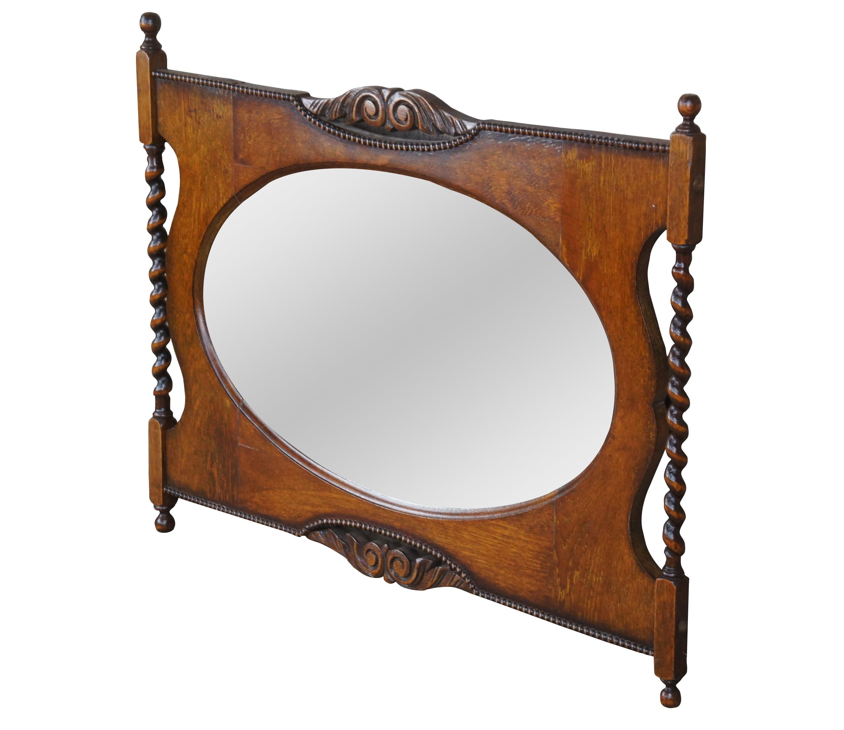 Antique Victorian parlor vanity mirror.  Made of quartersawn oak featuring ornate accents with gadrooned edge, ornate carvings, barley twisted supports and beveled oval mirror. 

Dimensions:
34