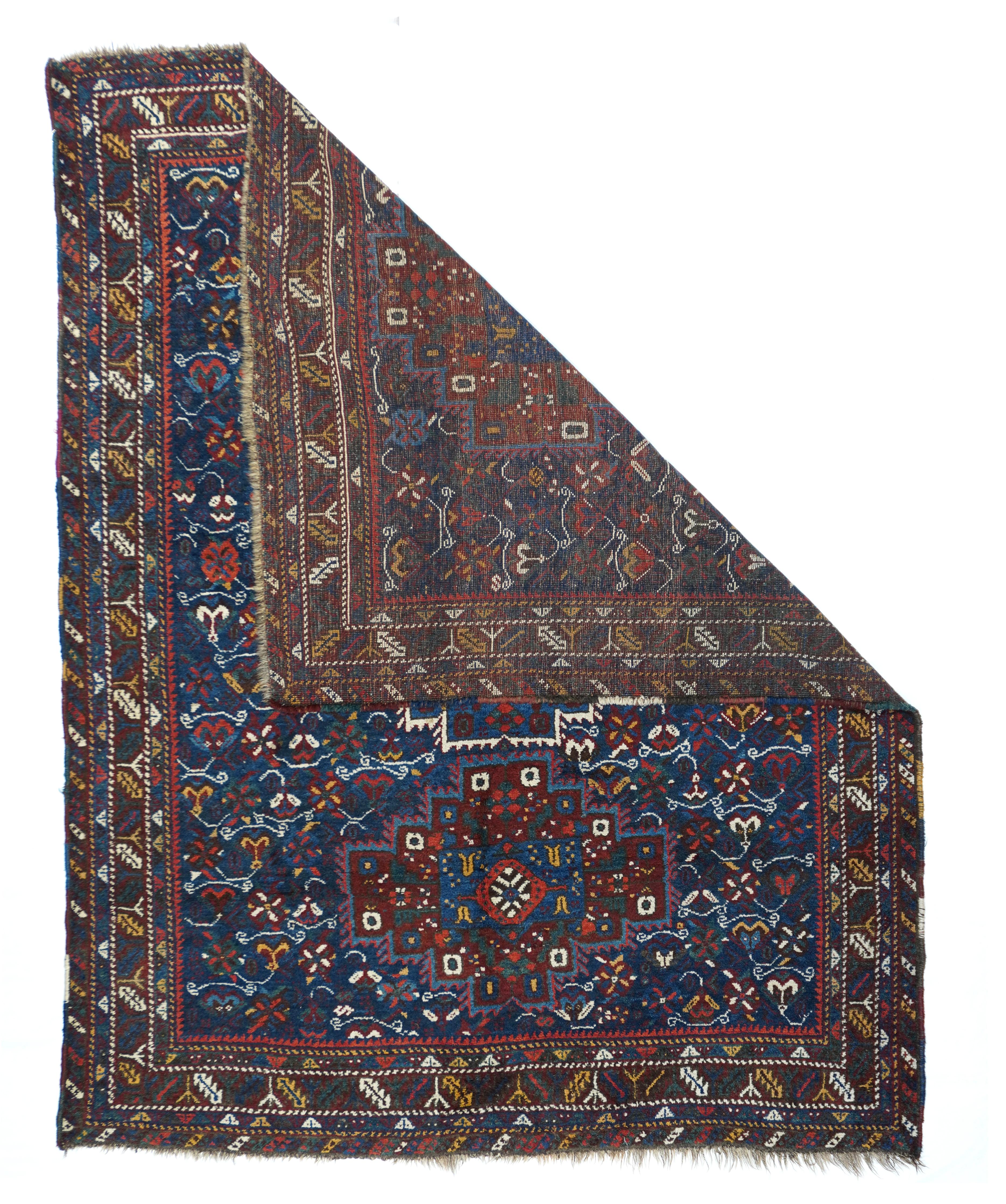 Antique Quashkai Shiraz rug measures 5'5'' x 7'1''. Not southwest Persian, but likely a SE Persian tribal creation with excellent indigo blues, both royal and cerulean. Three stepped octagon medallions are fringed in green or ivory and filled in