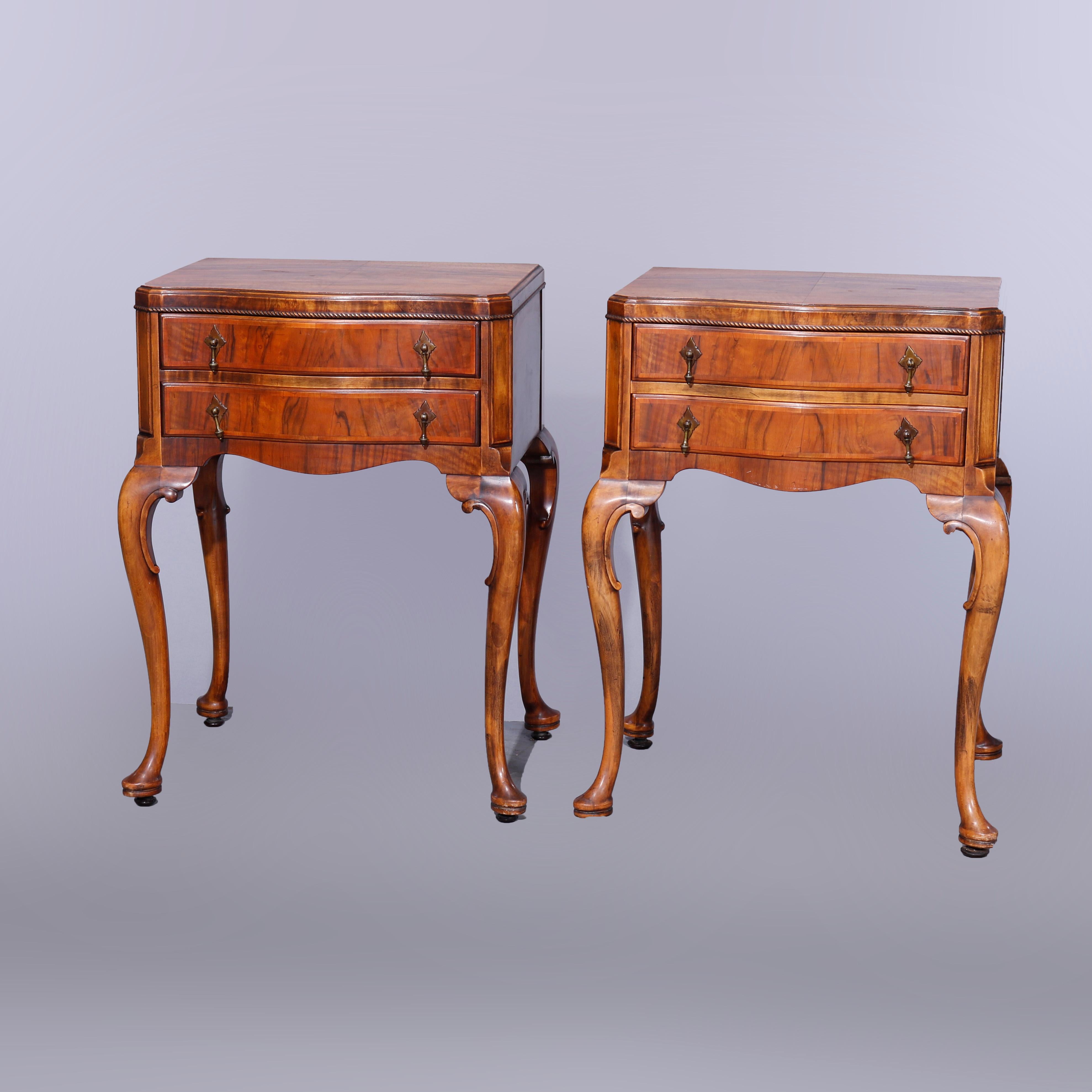 An antique pair of Queen Anne style side stands offer deeply striated English Circassian walnut construction with shaped tops over double drawer cases having rope twist trim and raised on cabriole legs terminating in pad feet, c1930

Measures -