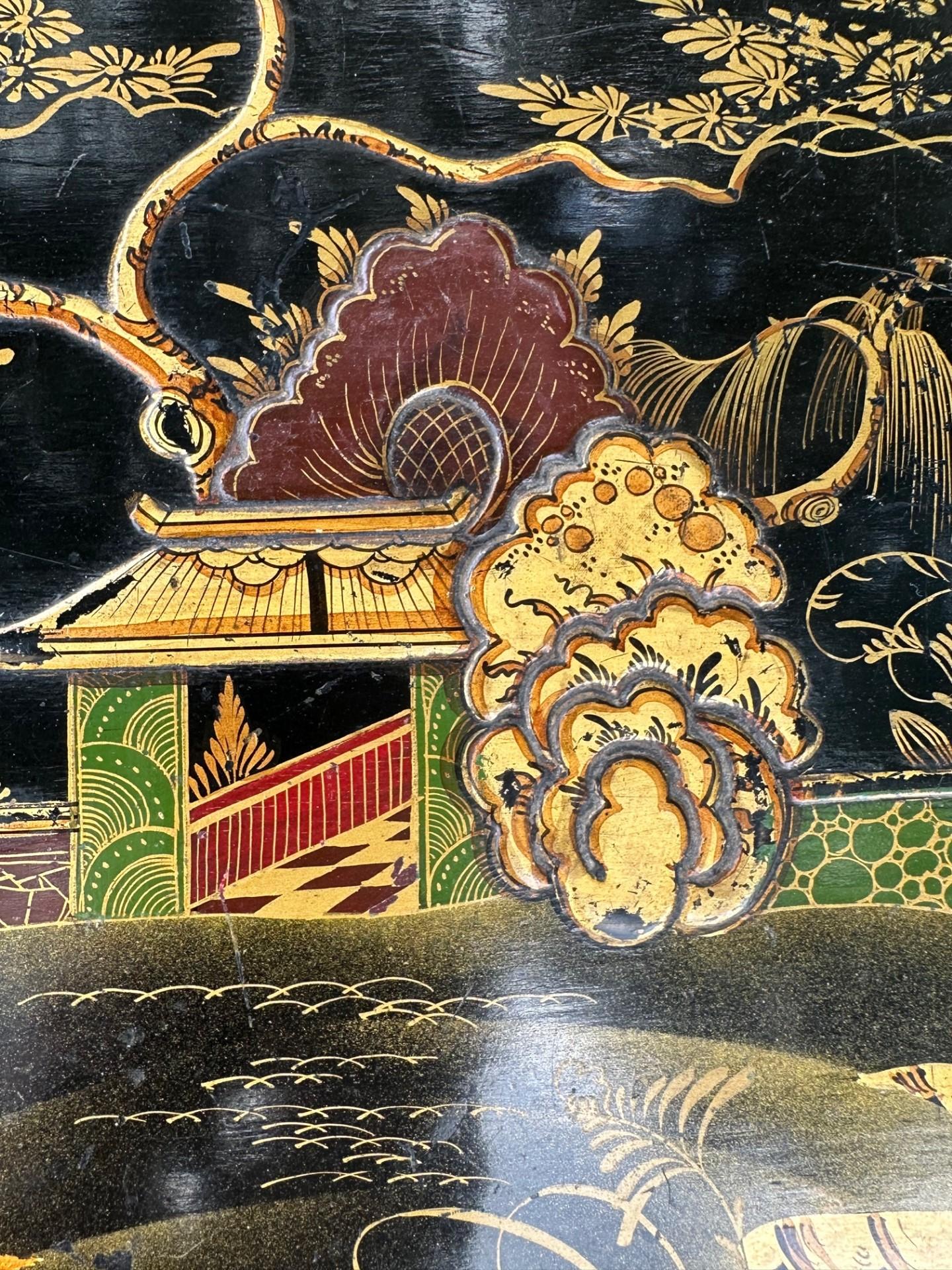 Antique Queen Ann Style with Raised Lacquer Chinoiserie Side Table

Charming side table from the early 20th century is hand decorated with gold gilt scenes of Asian landscape and figures on a black ground. The Queen Ann style table has great lines