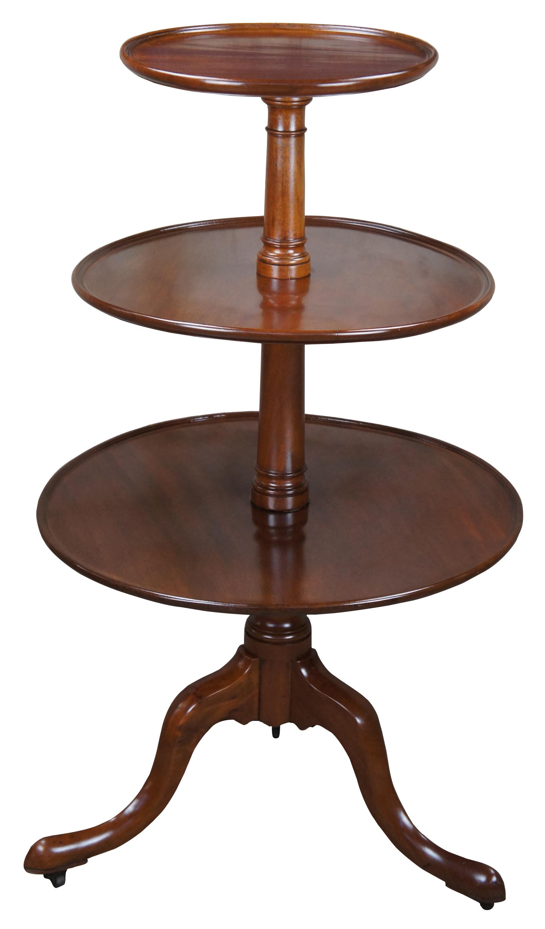 Antique 19th century three tiered dumbwaiter or butlers table. Made of mahogany featuring Queen Anne styling with a round tapered column and serpentine legs w slipper feet and castors.

Measures: 25.5