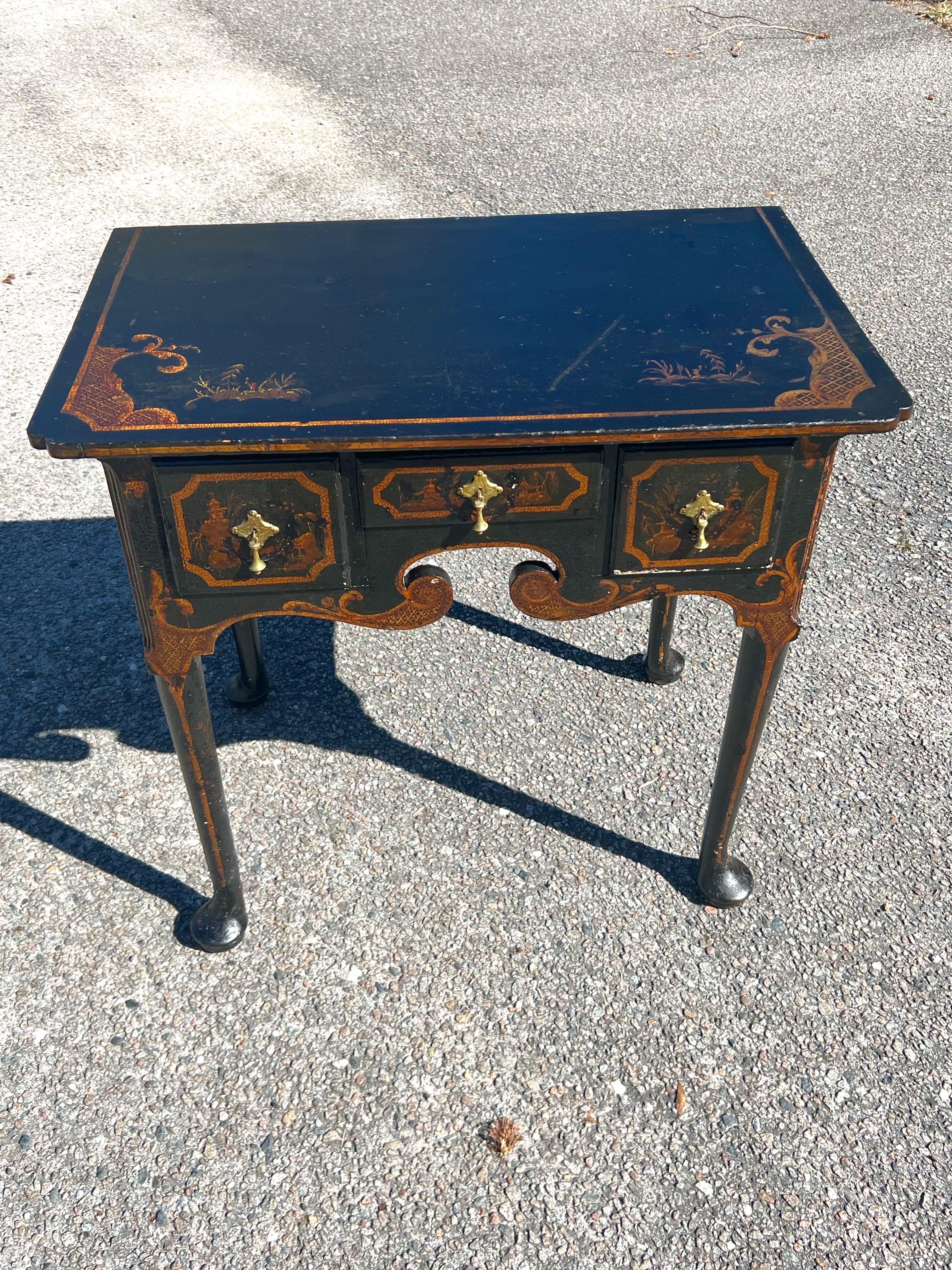 This is a rare form in a decorated lacquer surface, and a sturdy table that is very well built. The original top retains its first decorative Chinoiserie embellishments, as do the drawers, sides, and back. Looking at the images, one sees a