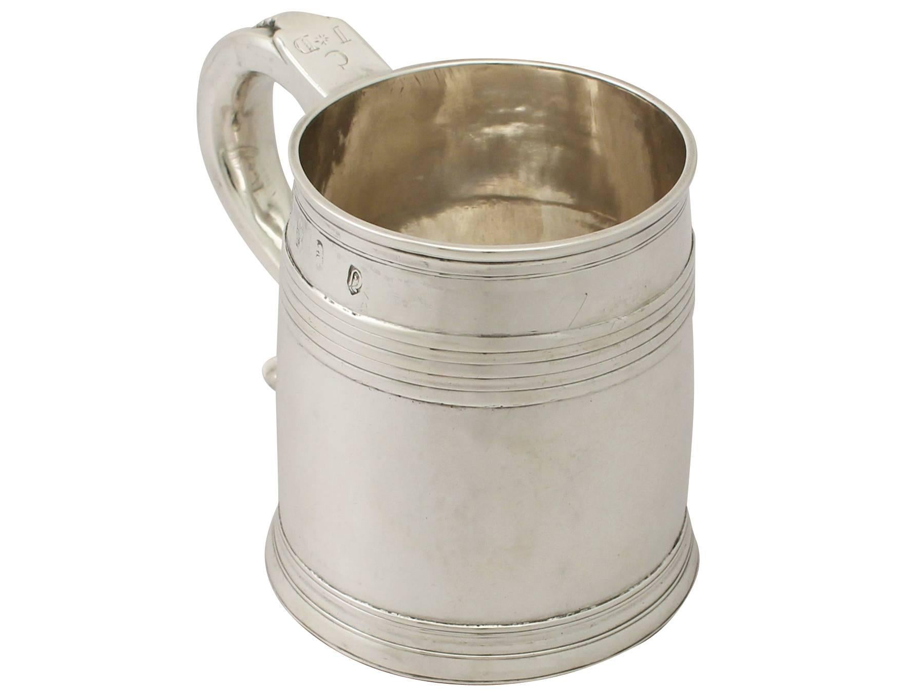 A fine and impressive antique Queen Anne English Britannia standard silver mug; an addition to our collectable early 18th century silverware collection

This impressive antique Queen Anne English Britannia standard silver mug has a plain tapering