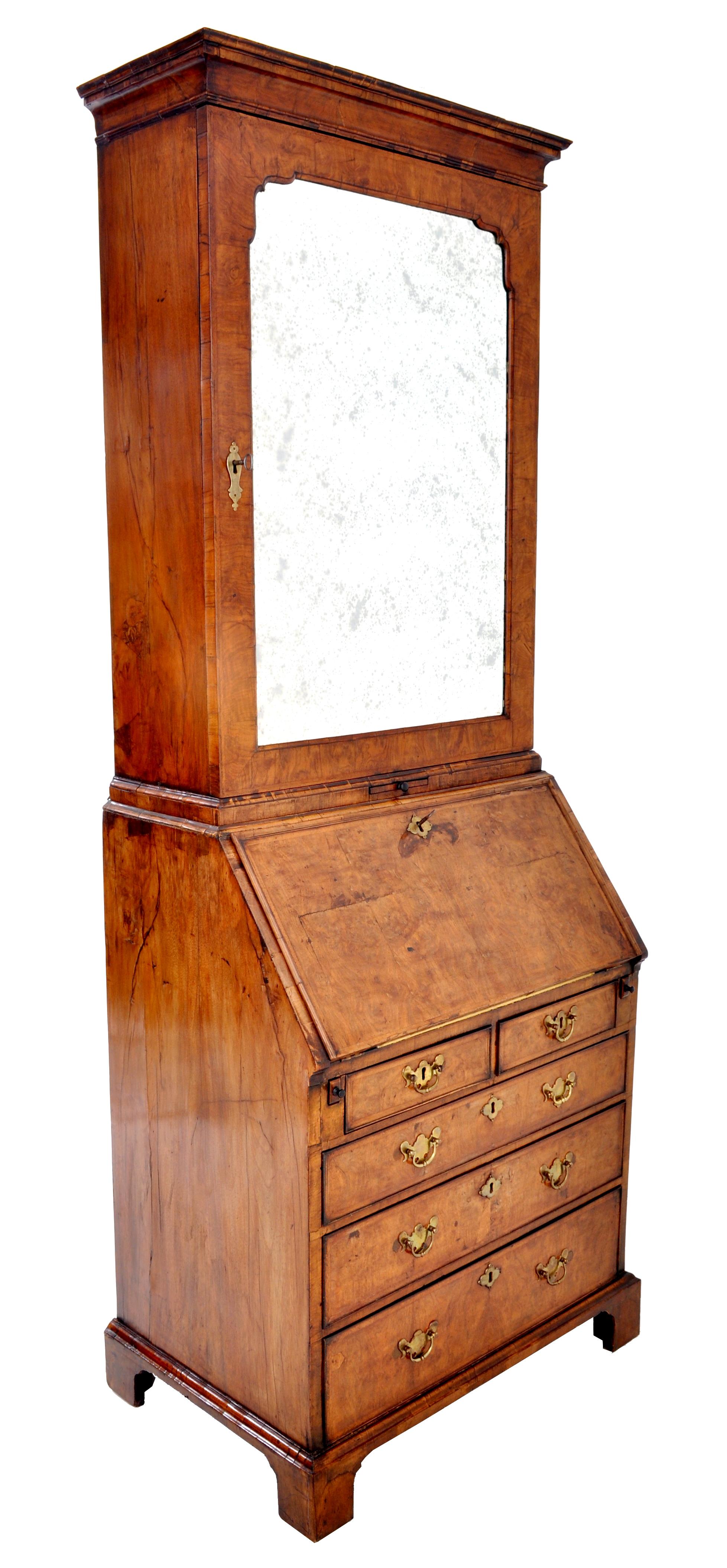 Antique Queen Anne Burl walnut bookcase / bureau / secretary desk, circa 1710. The bookcase in two sections and of diminutive form, having a top with a stepped cornice with a single beveled and shaped mirrored door enclosing three adjustable shelves