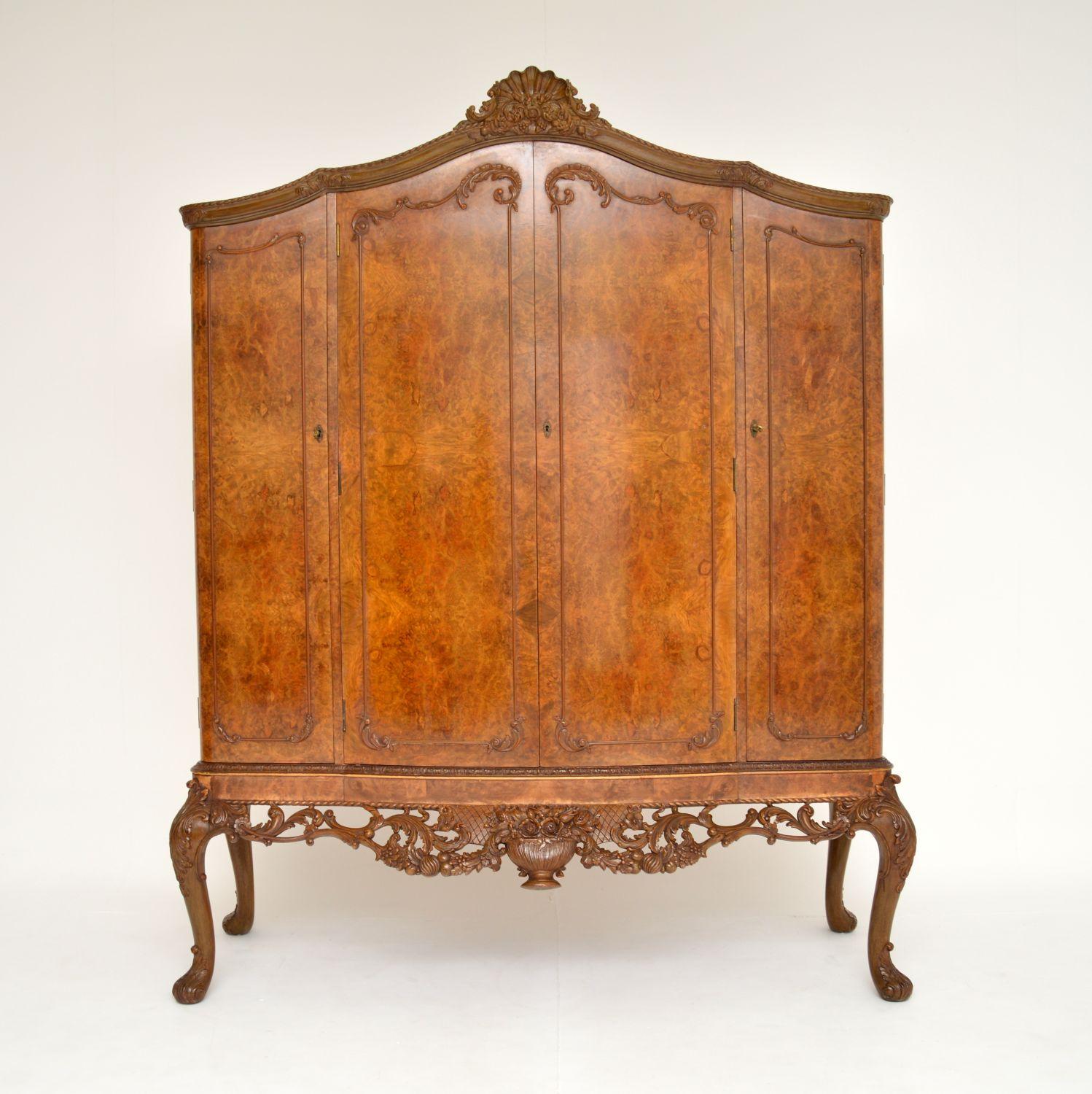 A magnificent antique burr walnut cocktail drinks cabinet in the Queen Anne style. This was made in England & dates from around the 1920-30’s period.
It is larger than the usual ones we find, and of absolutely superb quality. There are four doors