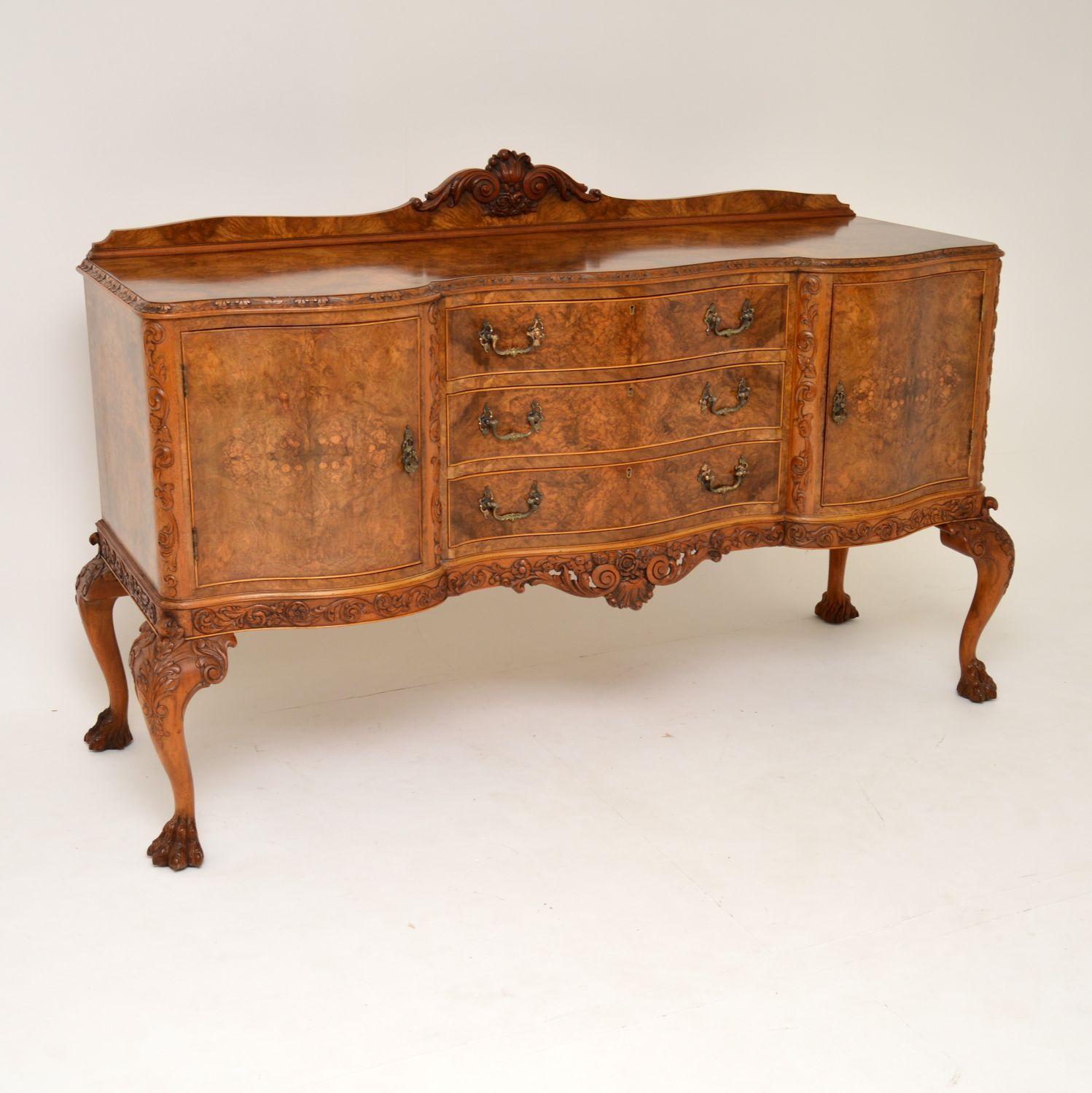 This antique burr walnut sideboard is stunning quality, with a wonderful shape and superb carvings.

This sideboard is antique Queen Anne style in walnut, dating to circa 1920s period. Please enlarge all of the images to see the wonderful deep
