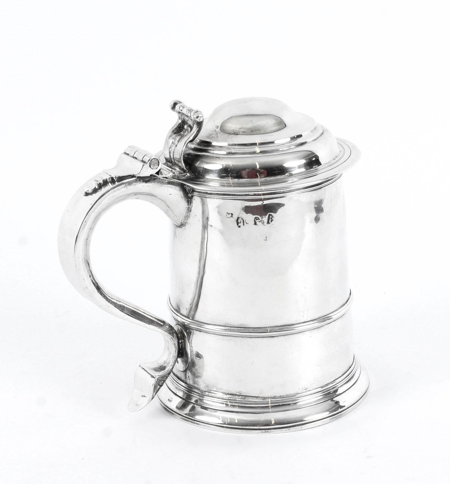 A wonderful antique Queen Anne silver lidded tankard with hall marks for London 1706 and the makers mark for Humphry Payne of Gurrer Lane, London, marked on base, cover and handle. 
 
This beautiful tankard is of cylindrical form with moulded