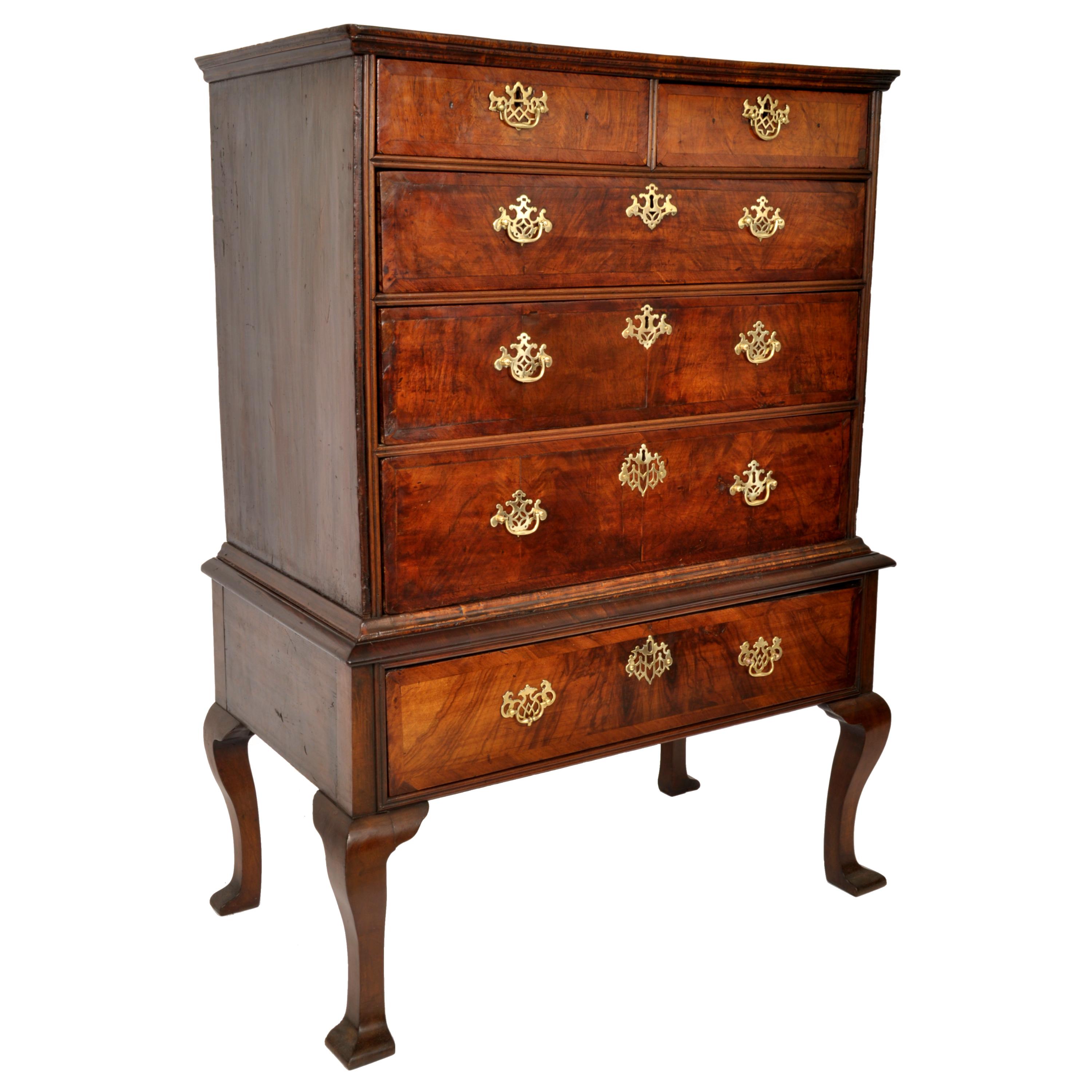 A fine & handsome walnut Queen Anne chest on stand/highboy, dating to the early George II period, circa 1740.
This unusually diminuitive highboy is made of the finest figured walnut, the highboy having a stepped cornice above two short drawers over