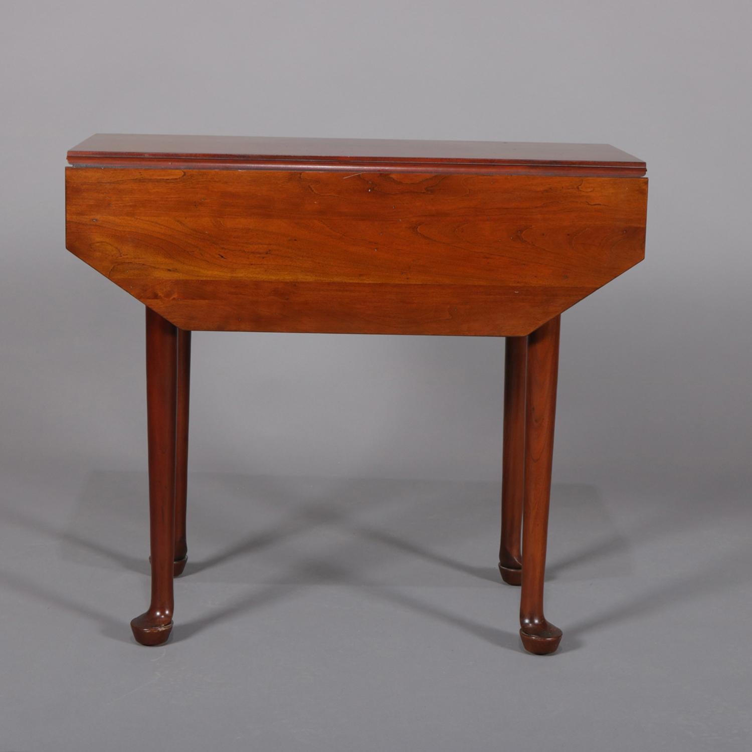 Antique Queen Anne pembroke table features mahogany construction with clip corner and drop leaf top raised on tapered legs with pad feet, circa 1890.

Measures: 25.5