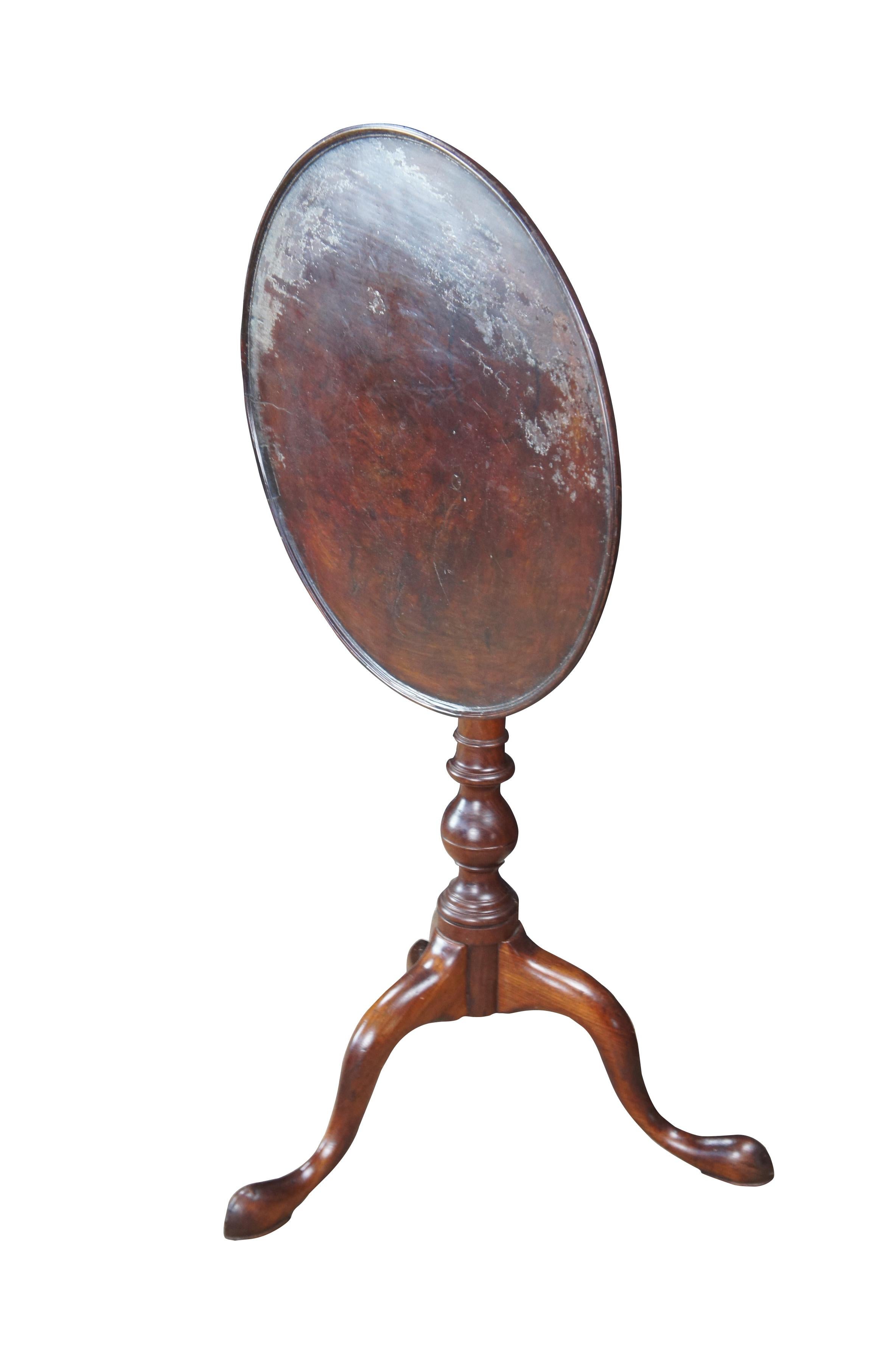 An American Queen Anne Tilt-Top Candle stand, tea or dessert table.  Circa 1770.  The table shows strong influences from Philadelphia. Features a finely turned dish top, birdcage, and suppressed ball turning. The base terminates in cabriole legs and
