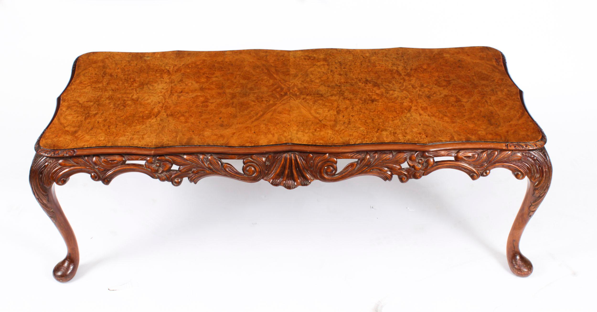 This is a stunningly beautiful English antique   burr walnut coffee table,  with a beautiful shaped top, circa 1920 in date.  

It features a shaped top with a fabulous hand carved edge.

The shaped carved frieze standing on well carved solid walnut