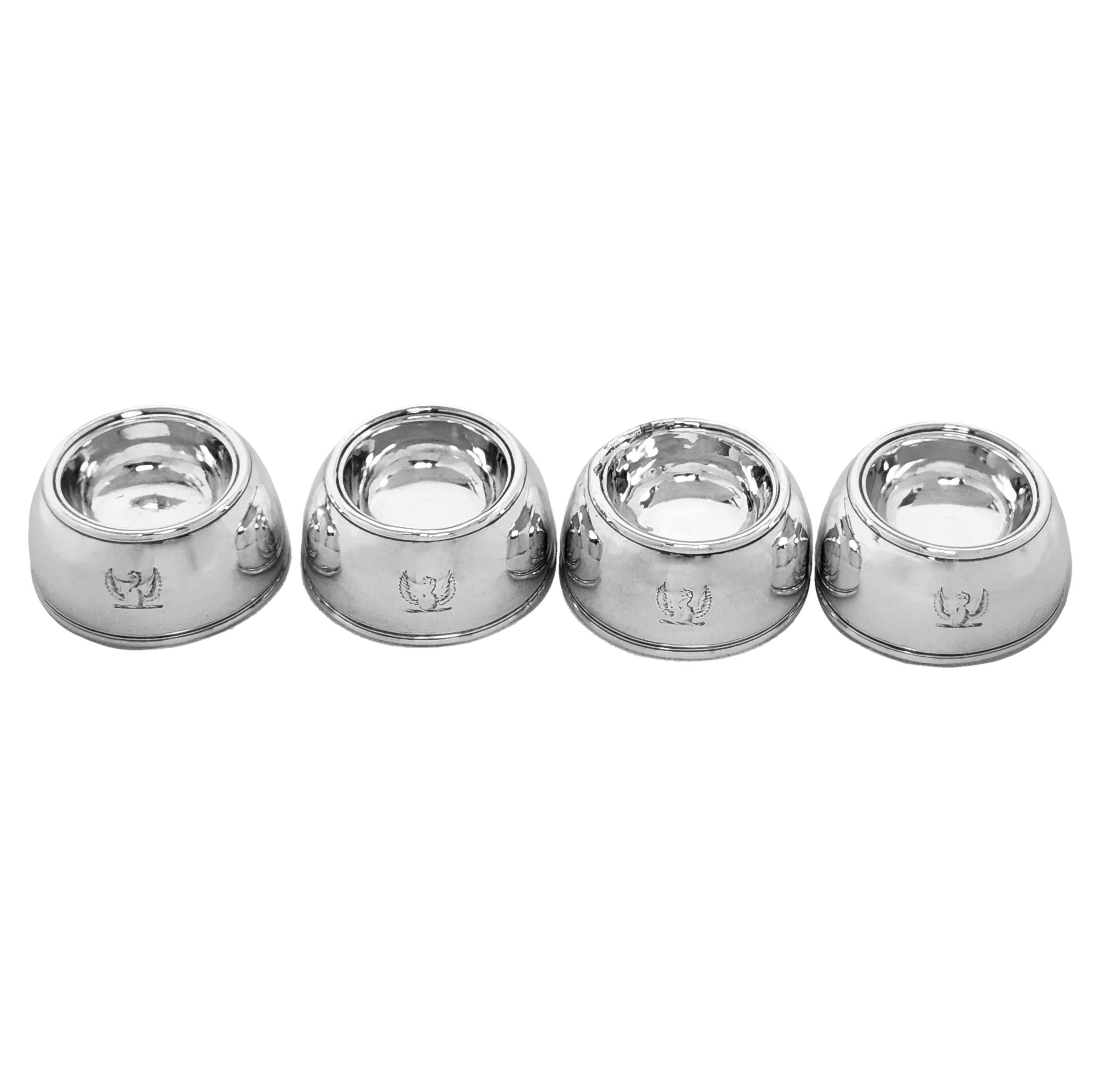 A set of 4 Antique Queen Anne Silver Salts. The early 18th Century Salts are in a classic round trencher shape and each has a small crest of a bird engraved on the side.

Made in London, England in 1714 by William Fleming.

Approx. Total Weight -