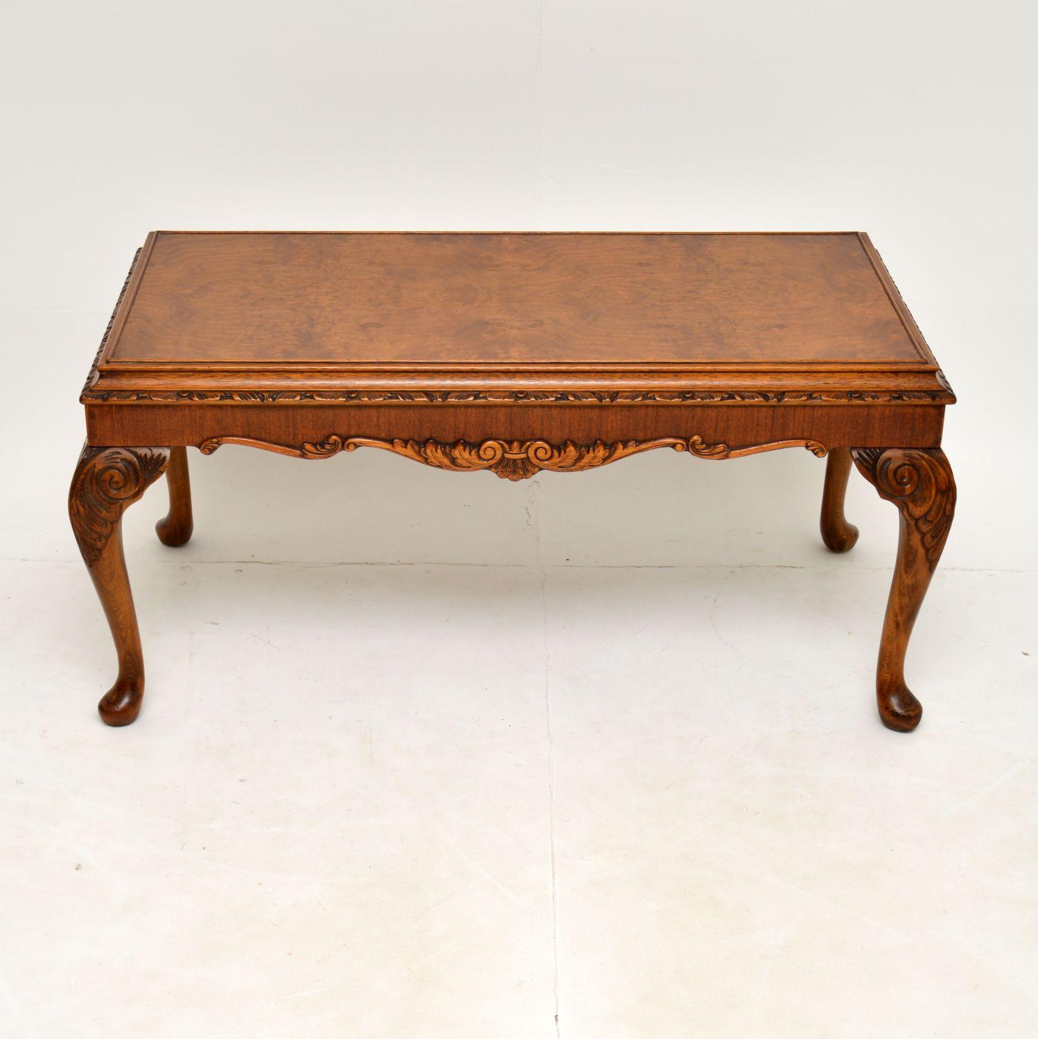 A wonderful antique walnut coffee table in the Queen Anne style & dating from around the 1930’s period.

This table is of lovely quality, with fine carvings around the top & bottom edges and on the tops of the shaped legs. It has a cushioned top