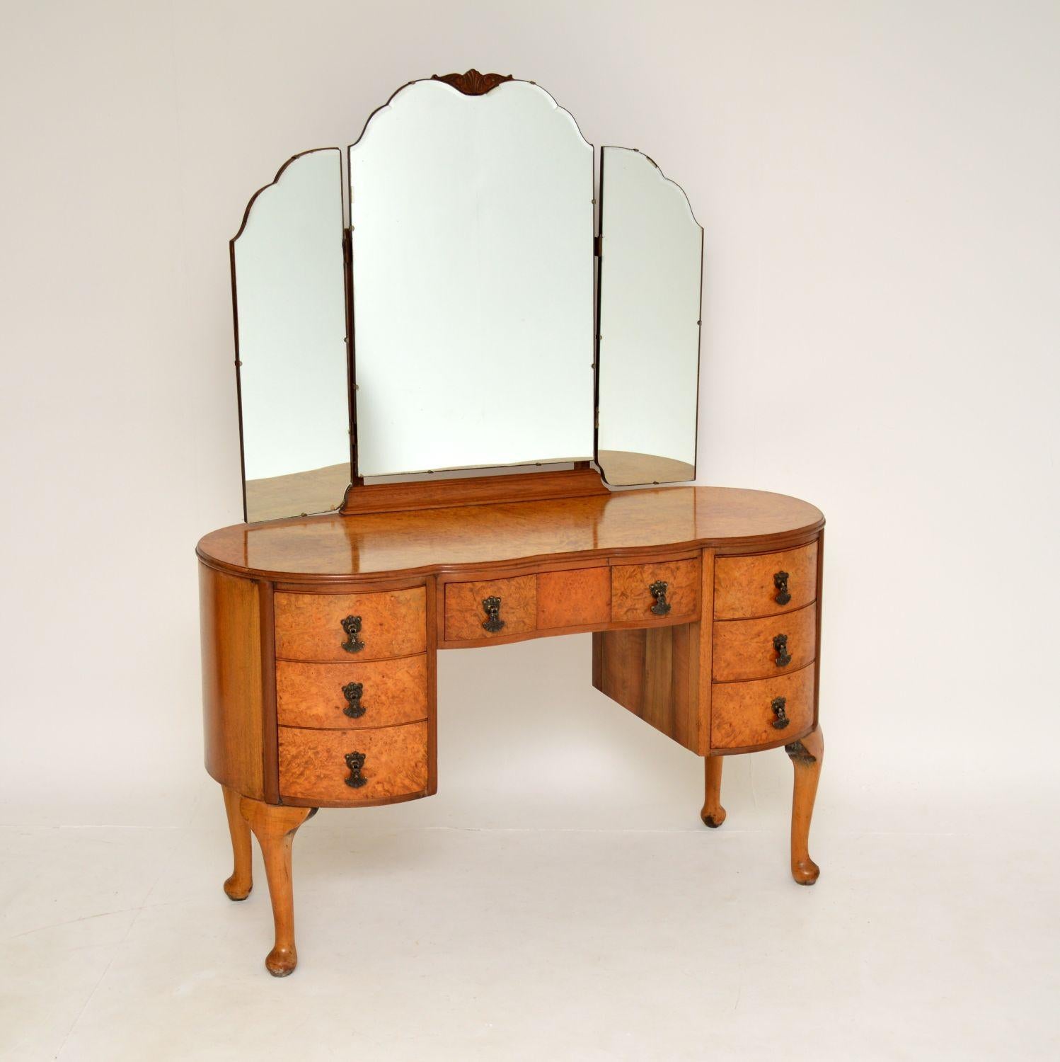 A beautiful antique burr walnut dressing table in the Queen Anne style & dating from around the 1930’s period.

This is very well made and has a wonderful shapely design. It is a very useful size and looks great from all angles, there is plenty of