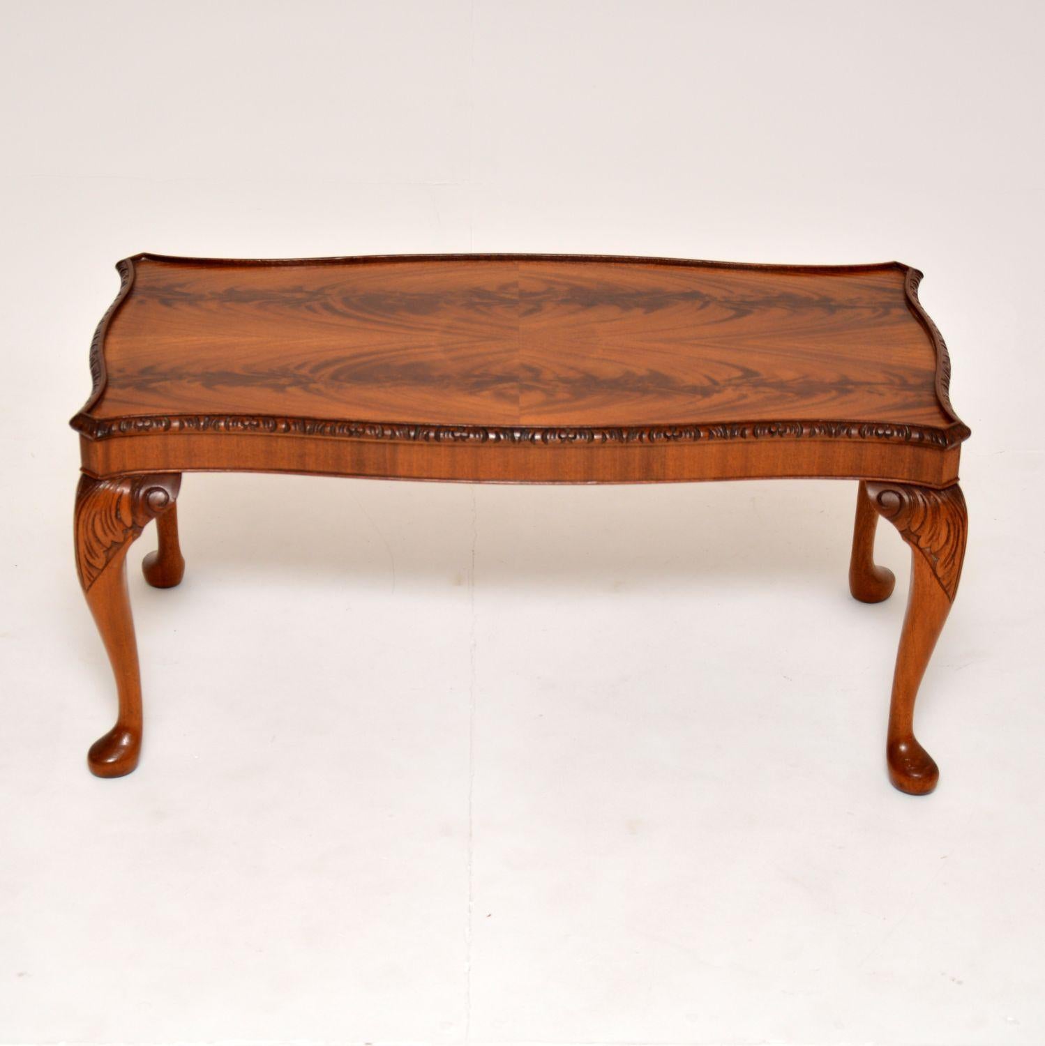 A lovely antique coffee table in the Queen Anne style. This was made in England, it dates from the 1920-30’s.

It is of fantastic quality, with beautifully carved serpentine edges. It sits on sturdy cabriole legs with fine acanthus leaf carving. The