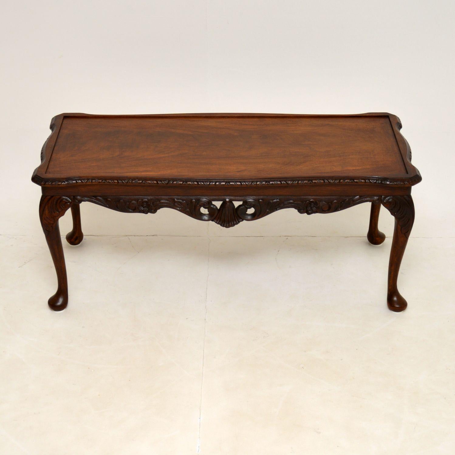 A fine quality mahogany coffee table in the antique Queen Anne style. This was made in England & dates from around the 1930-50’s.

There is lovely carving around the edges and legs, with beautiful flame mahogany veneers on the top.

This has