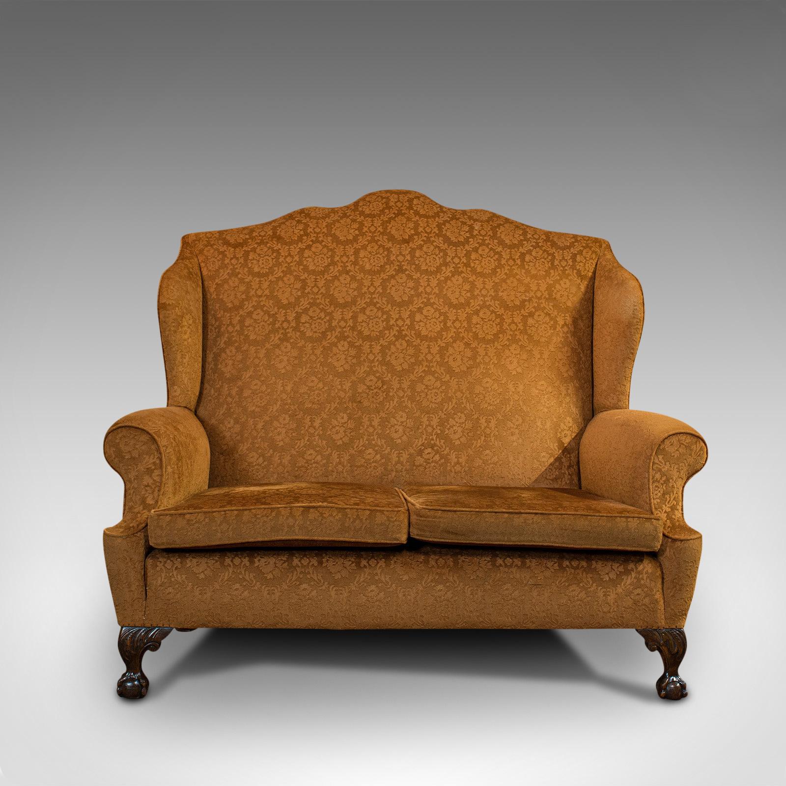 This is an antique Queen Anne style sofa. An English, upholstery and mahogany two seat settee, dating to the Victorian period, circa 1880.

Rich yellow hues and superb patterned upholstery
Displays a desirable aged patina
Traditionally stuffed,