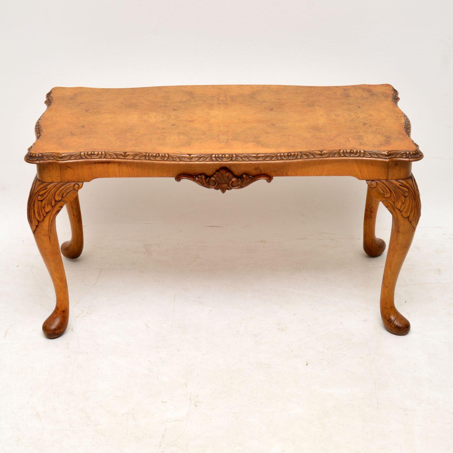 This antique Queen Anne style walnut coffee table has a lovely mellow color and is in good original condition. It dates to circa 1930s period and has just been French polished. The shaped top is burr walnut and there are carvings on the top edge,