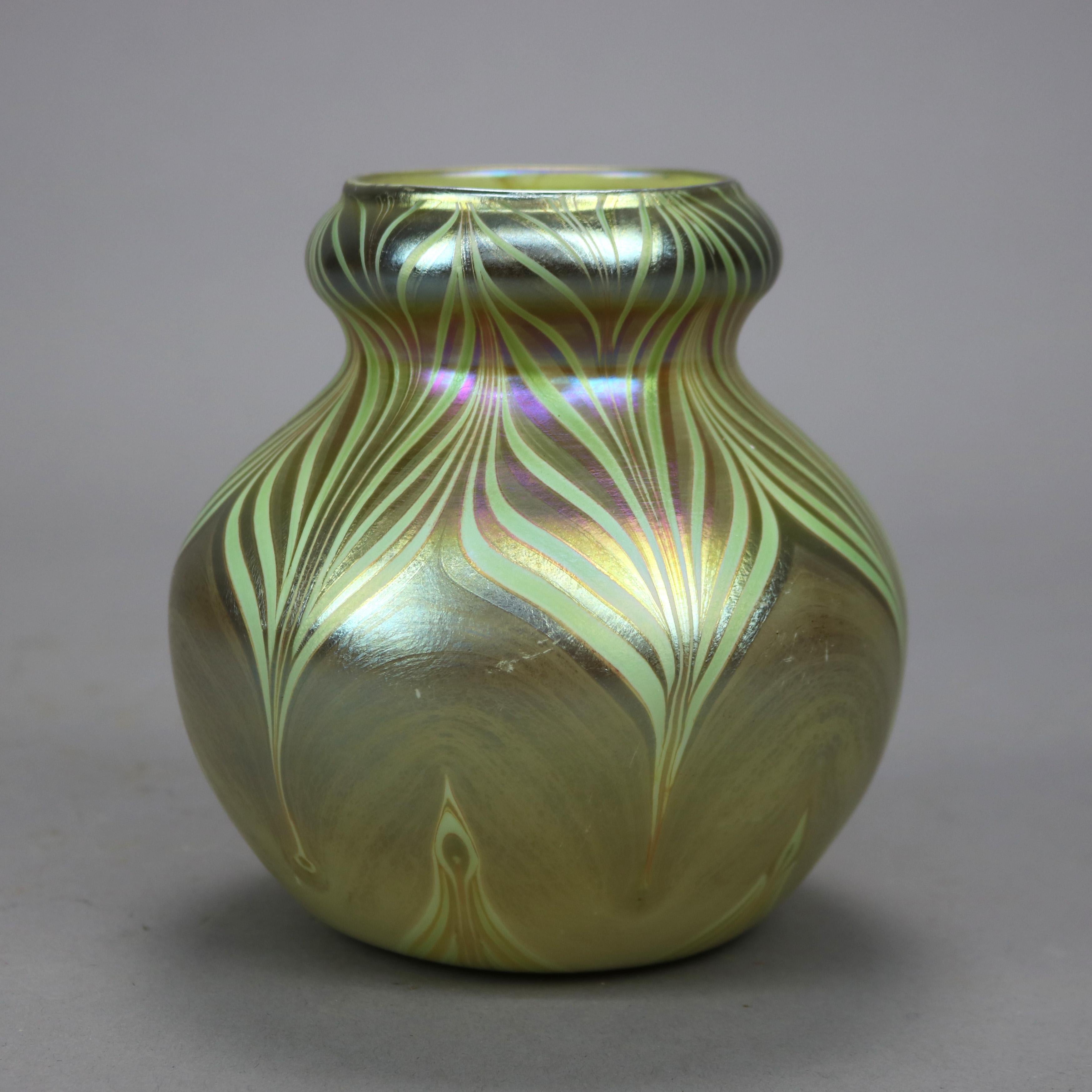 An antique Arts and Crafts vase attributed to Quezal offers art glass construction in bulbous form with pulled feather pattern, unsigned, c1930

Measures - 5.75''H x 5.25''W x 5.25''D.