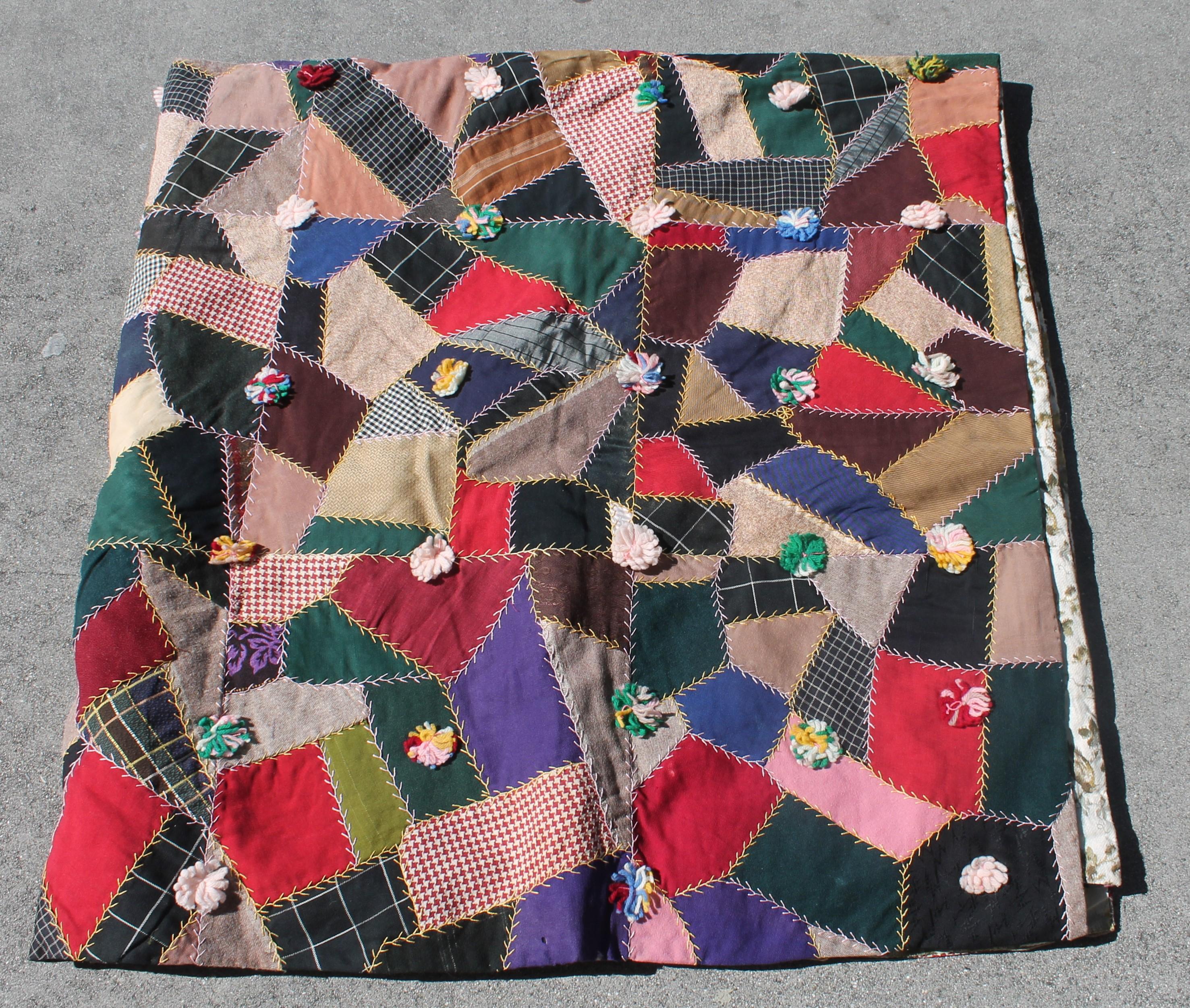 This fun and folky hand pieced and quilted crazy quilt is in great as found condition with folky little ties as well. The condition is very good and as well as the hand tied wool ties. This contained crazy quilt / comforter was from Lancaster