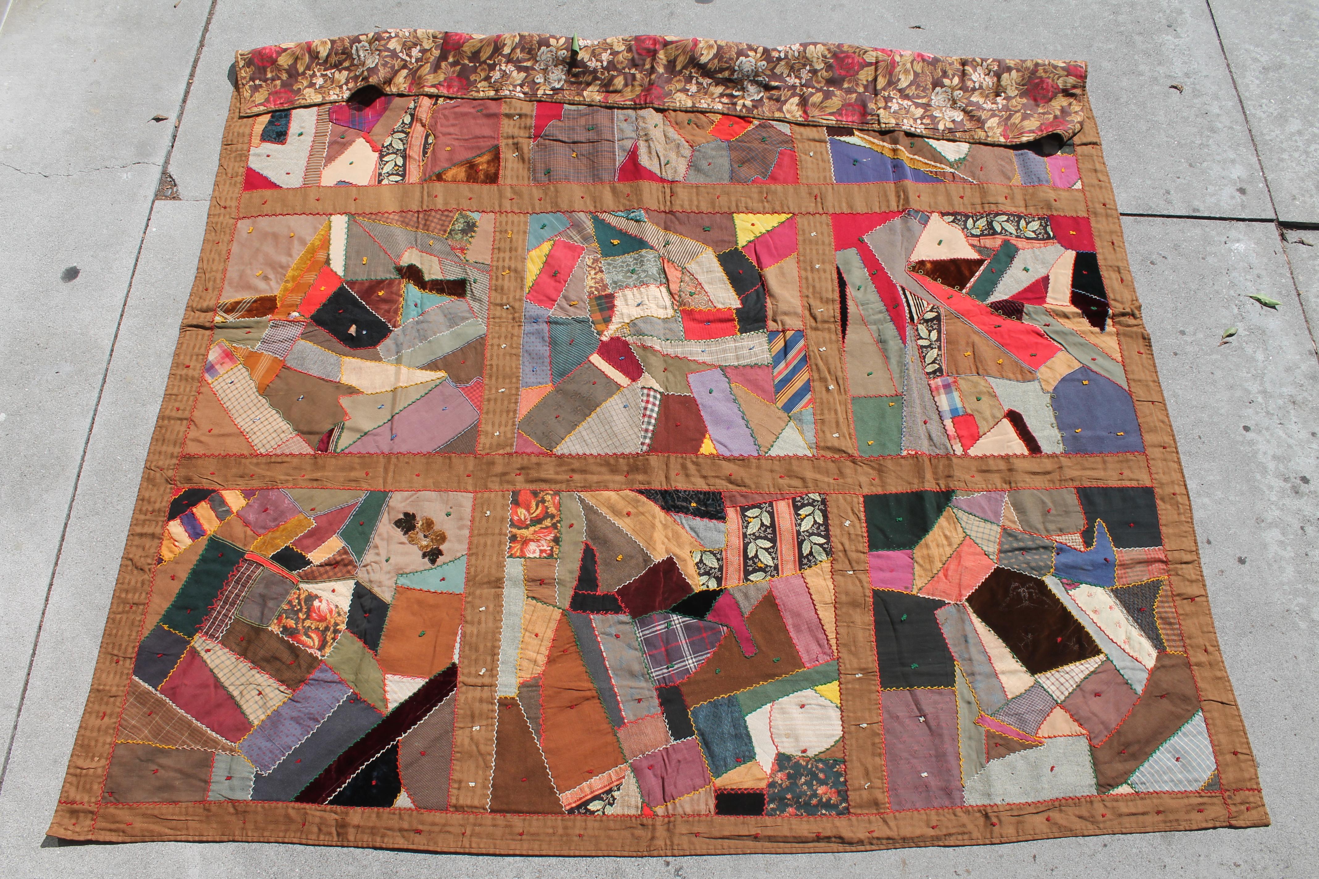 This fantastic crazy quilt is made up from wool and velvets fabrics. The backing is in a wild 19th century tropical printed wool Chalis fabric. The condition is very good. Found in Lancaster County, Pennsylvania. It consists of great fabrics!
