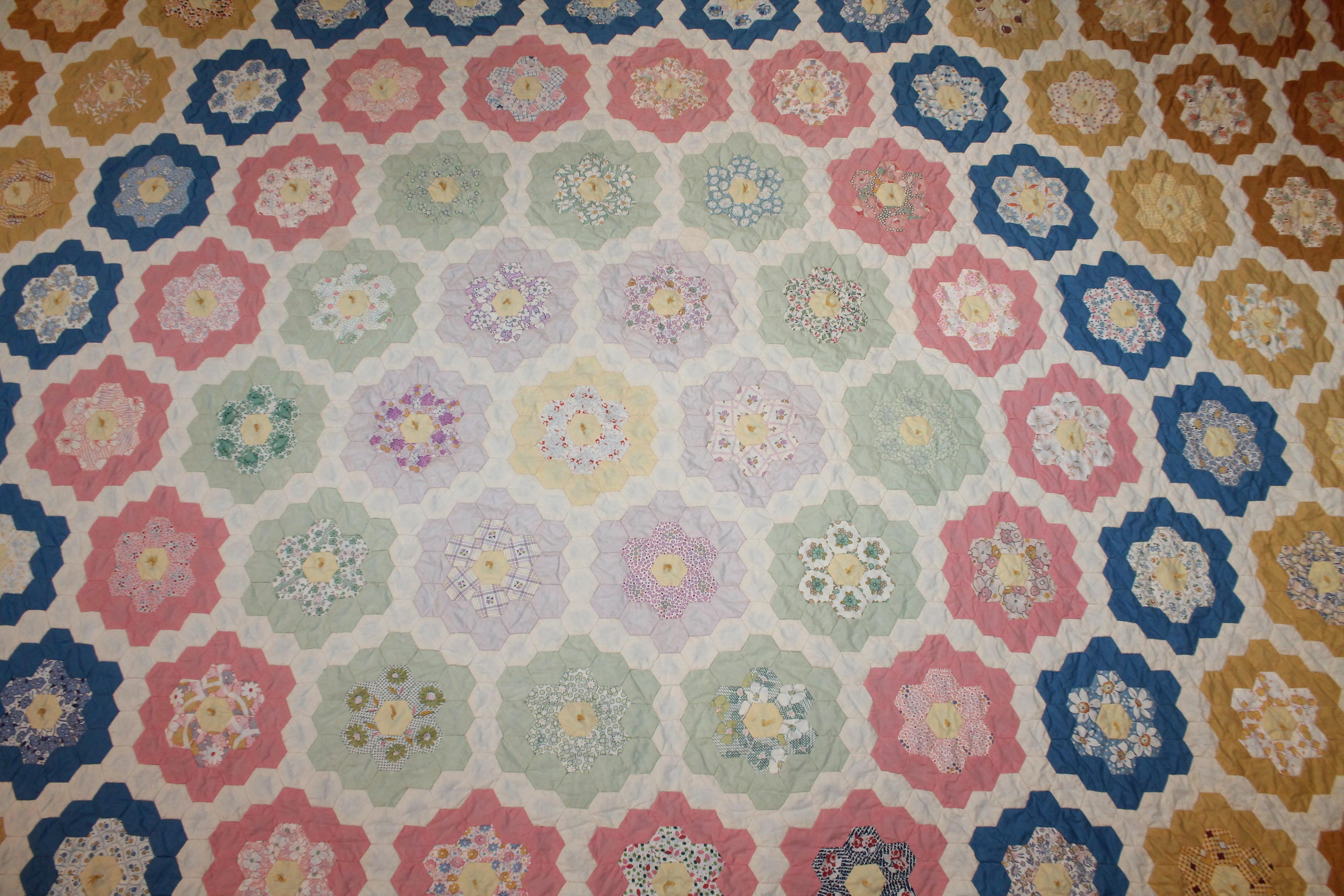 Early flower garden summer quilt with a blue shambray backing.
The condition is very good. This quilt has tiny stitching and piecing. It is also hand tied.
Early honey comb pattern.