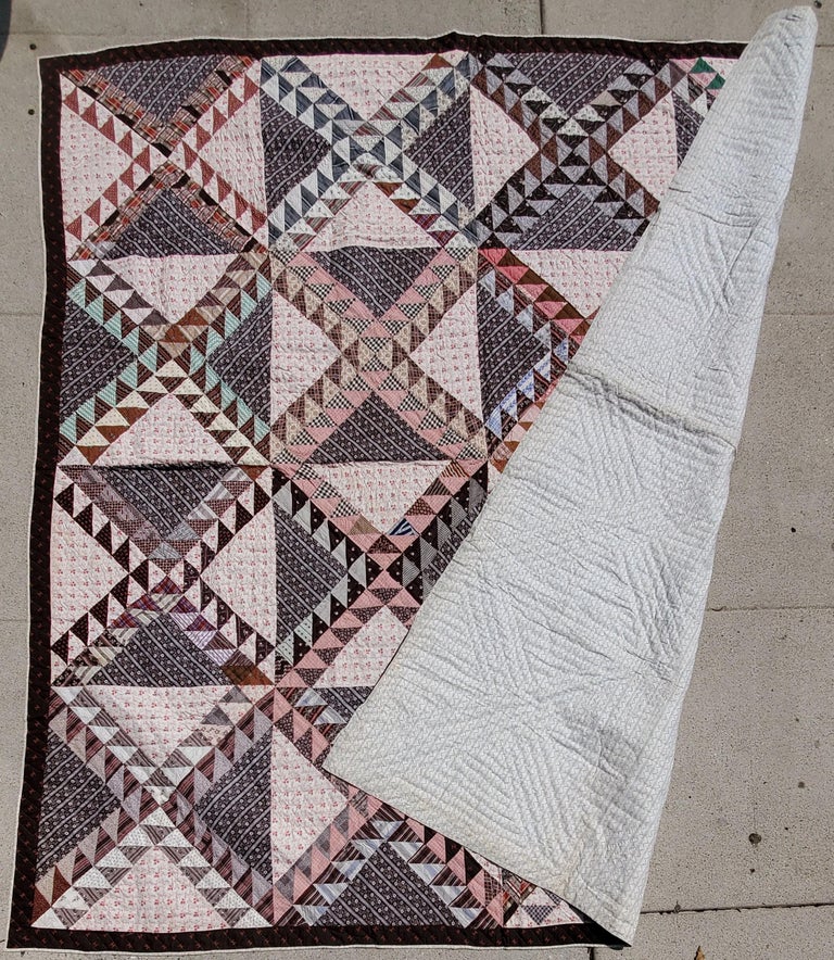This fine antique quilt was found in Adams County, Pennsylvania and is in pristine condition. The usage of many early shirting fabrics and early brown calico fabrics.