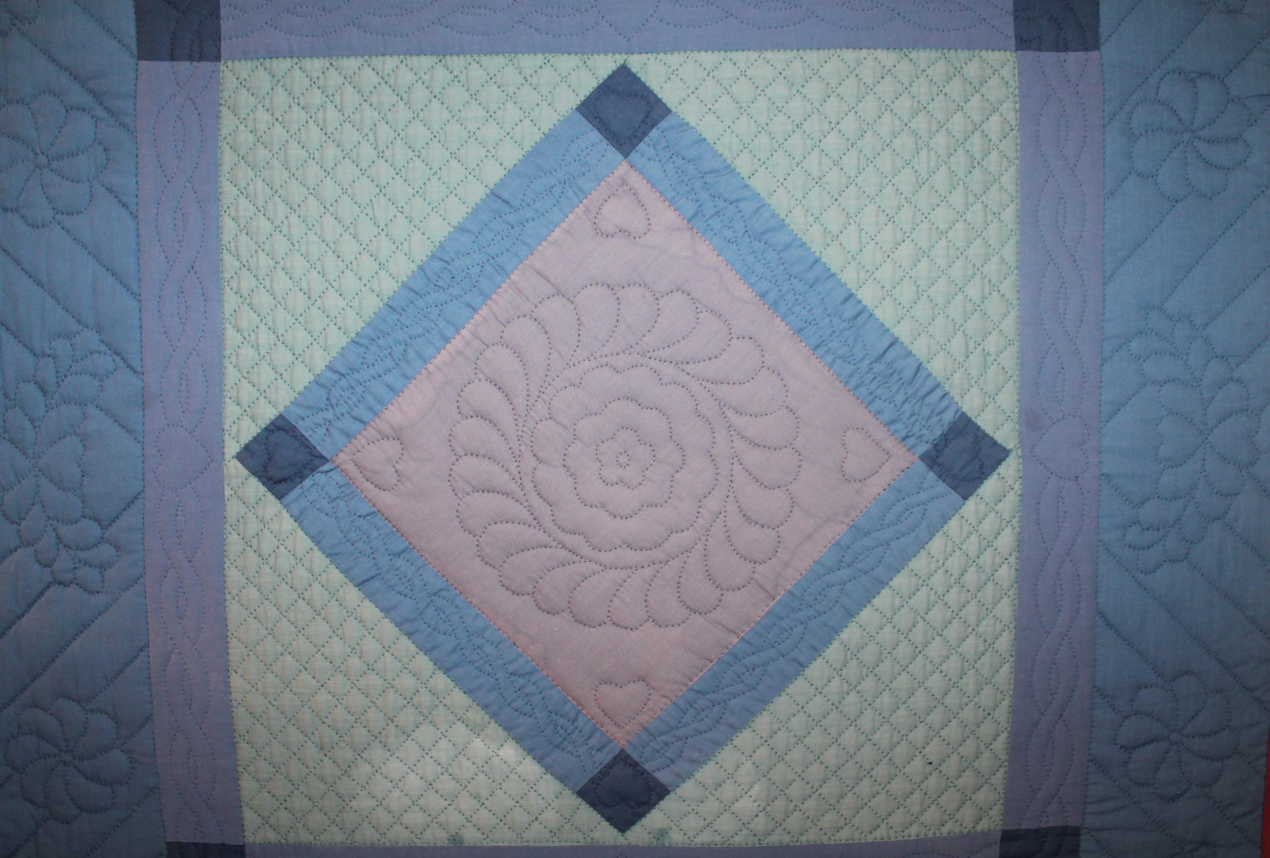 Amish mounted diamond in a square crib quilt from Lancaster County, Pennsylvania. This rare and very unusual all cotton crib quilt is in very good condition with slight lighted colors.