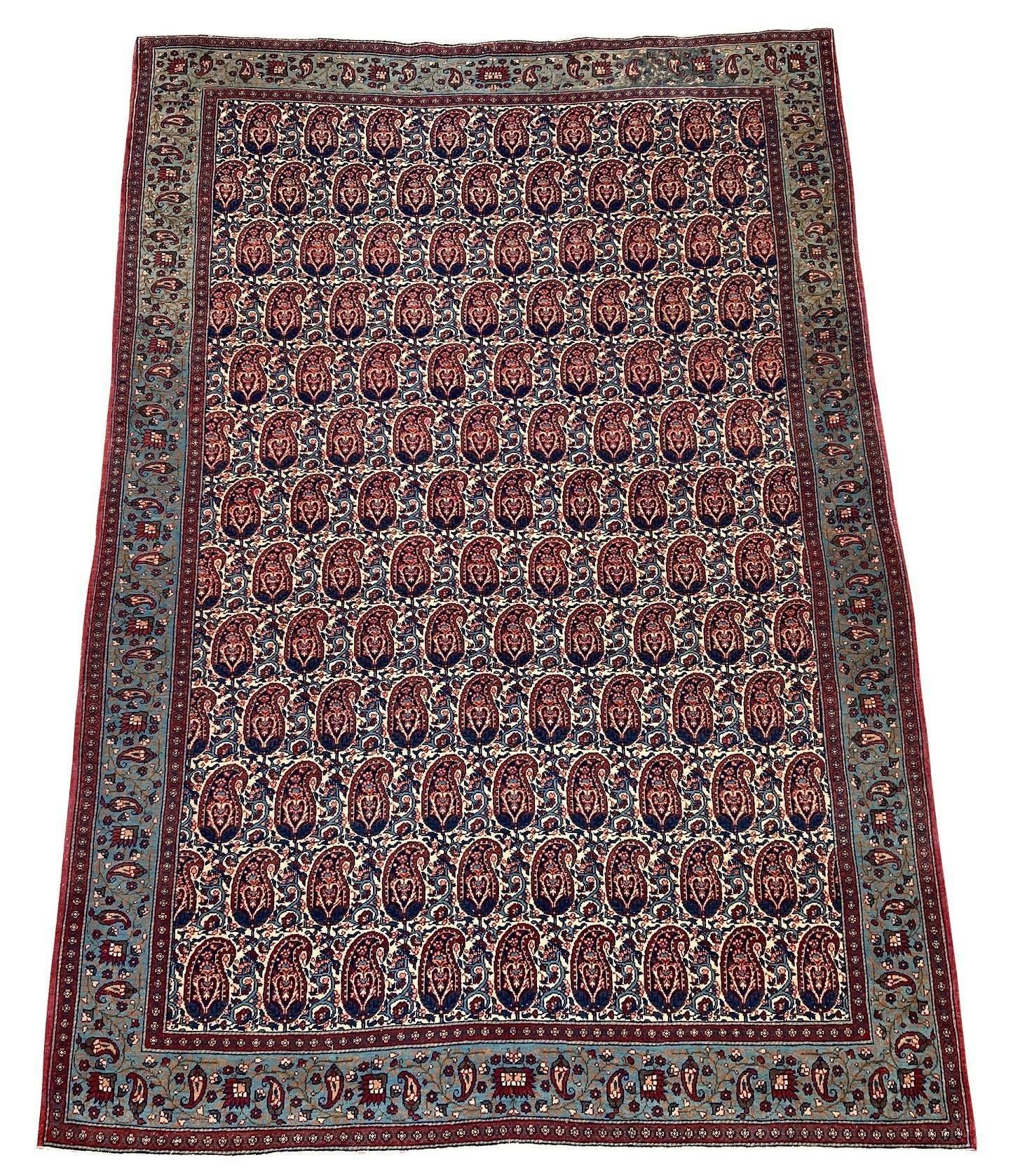 A fabulous antique Qum rug, handwoven circa 1910 with an all-over boteh design on an ivory field and pale indigo border. Finely woven with lovely wool quality and stunning colours make this a very decorative antique rug.
Size: 2.00m x 1.36m (6ft 7in