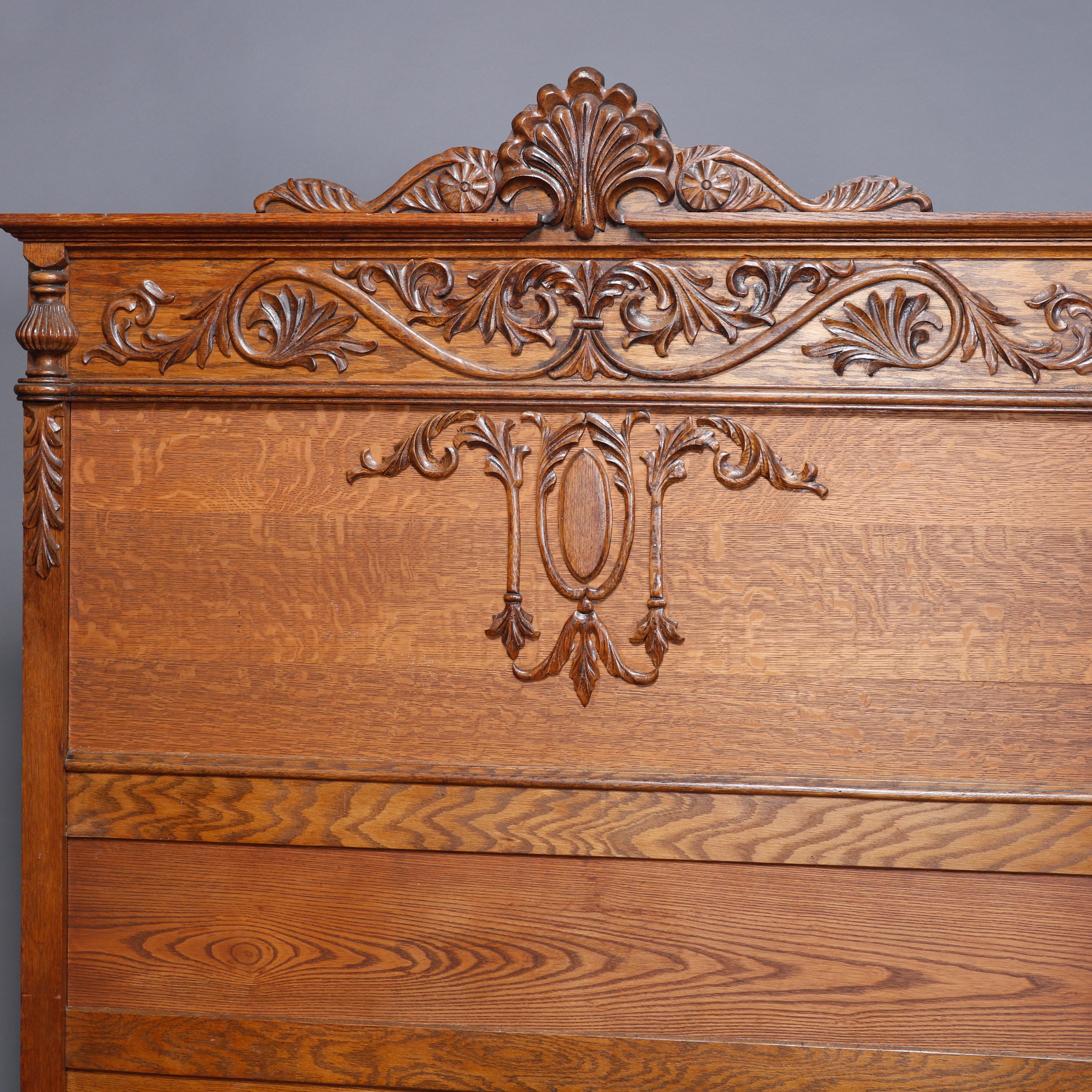 An antique R.J. Horner full or double bed frame offers oak construction with tall back having carved palmette crest with flanking scroll and foliate acanthus elements, raised on scroll form feet, circa 1910

Measures: 79.75