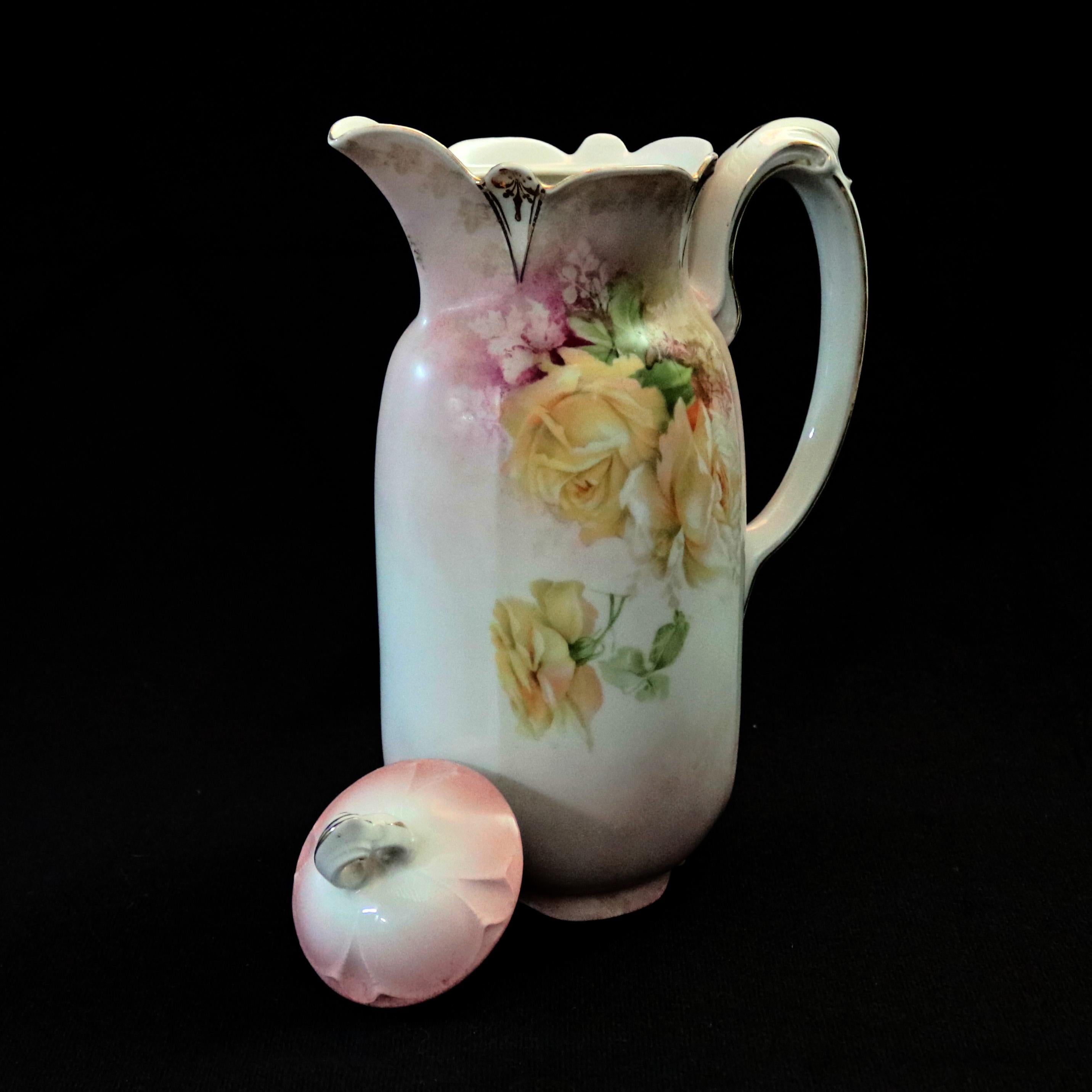 An antique hand painted R. S. Prussia porcelain pitcher offers scalloped lip with lid surmounting faceted vessel with yellow roses, RS Prussia stamp on base as photographed, circa 1920.

***DELIVERY NOTICE – Due to COVID-19 we are employing