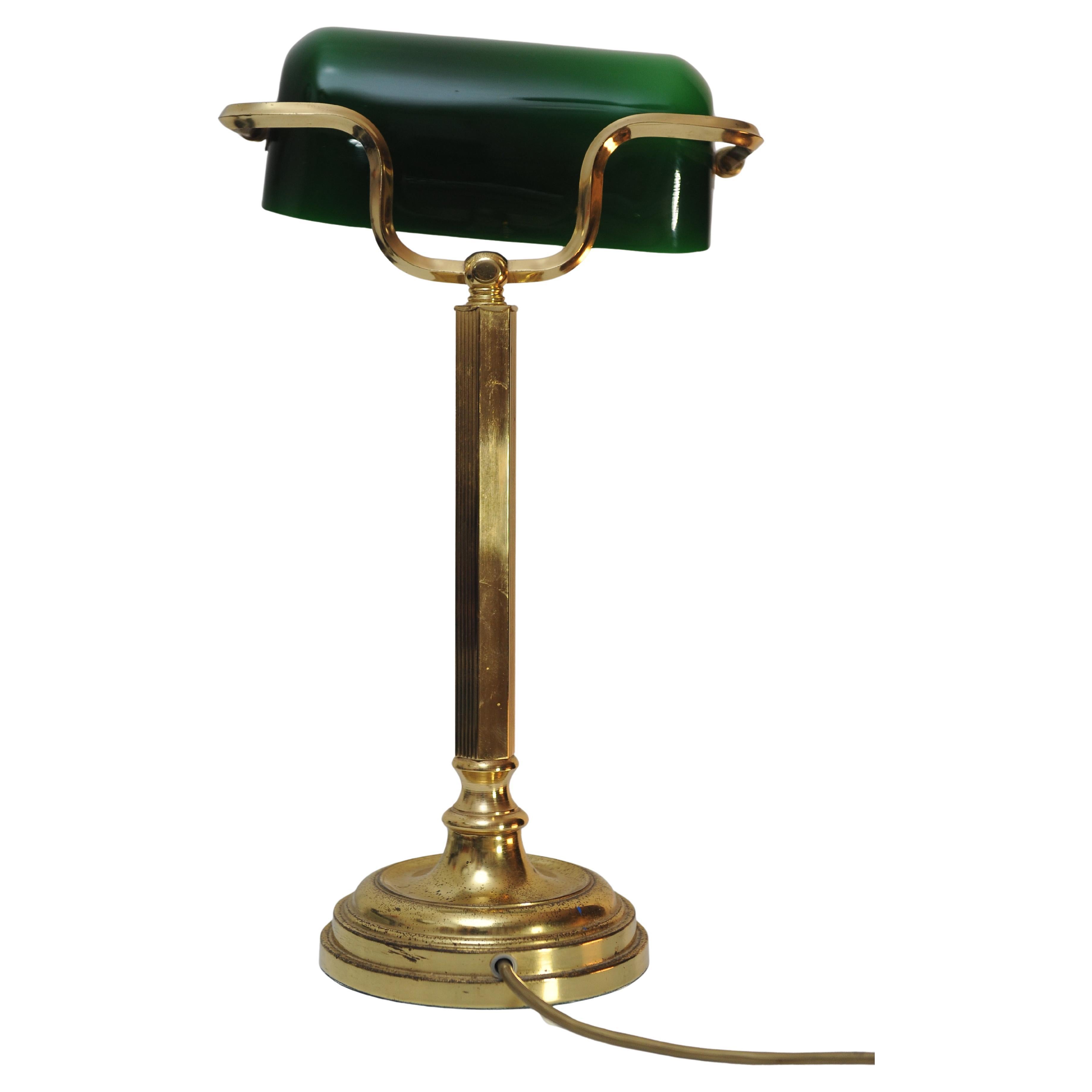 An Iconic Antique Green Brass Bankers Lamp With Brass Adjustable Shade, Heavy Brass Stand and Baize Bottom.
Ideal for any desk setting or reading side table.