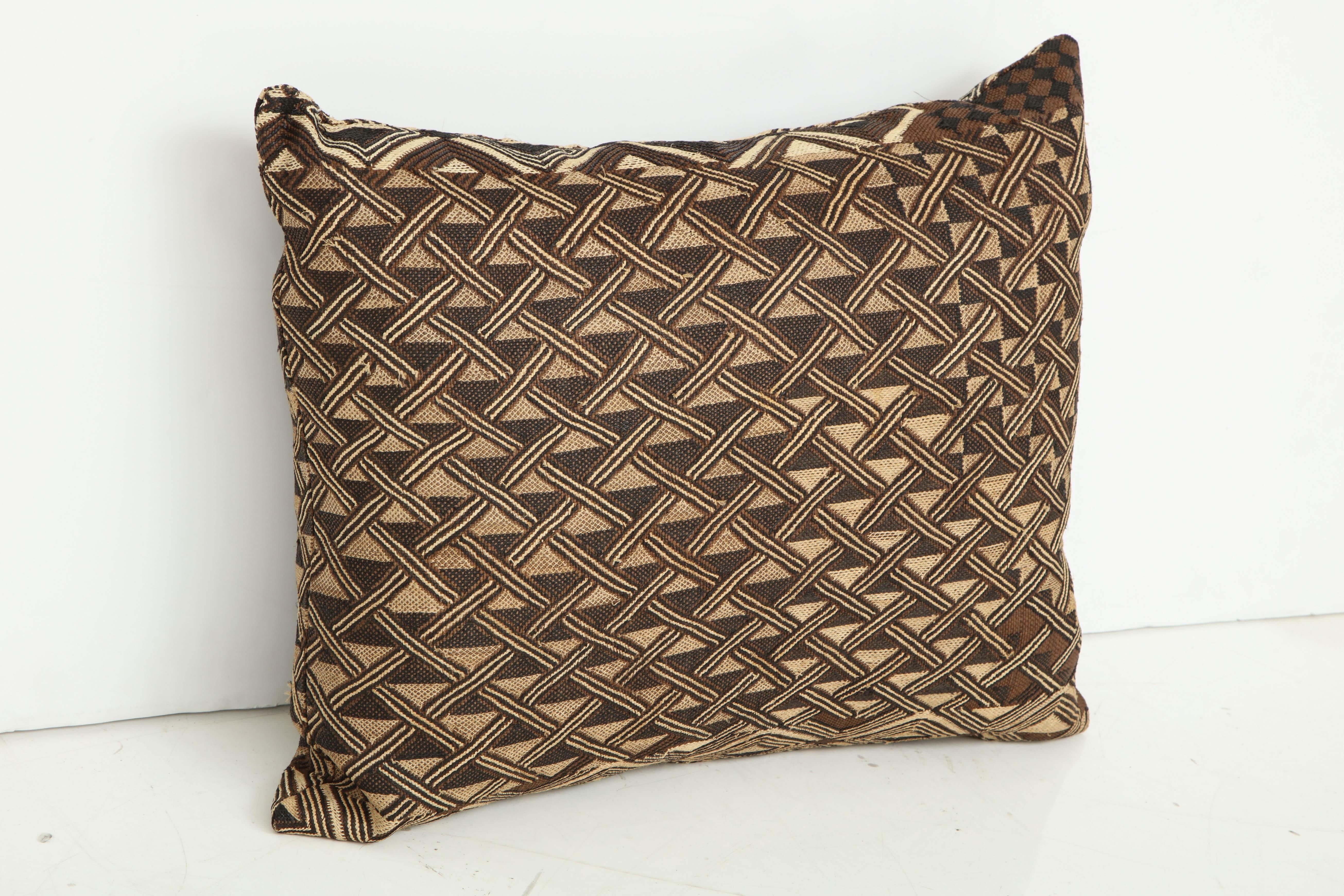 Antique Raffia Kuba cloth pillow, beige and brown pattern.