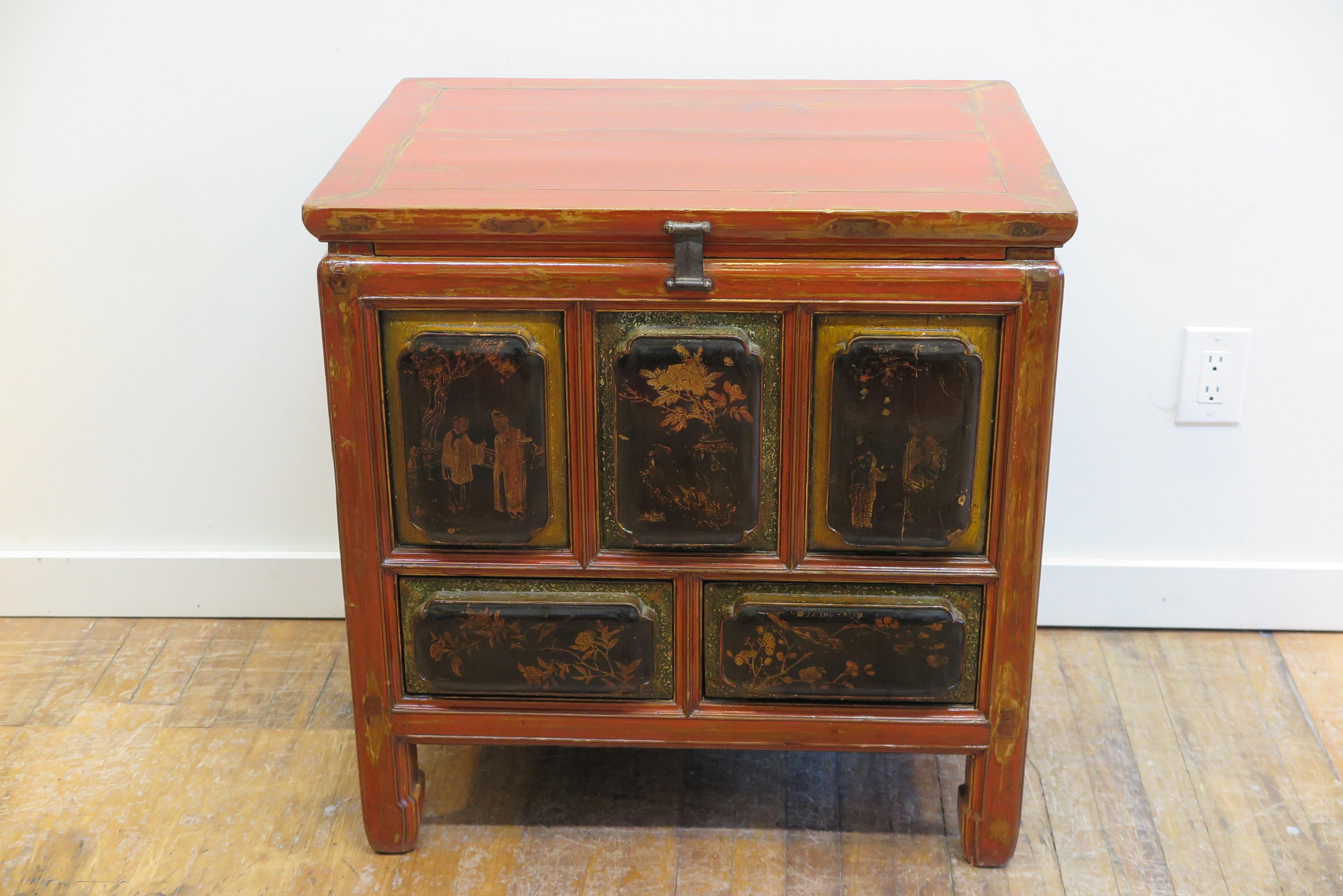 Chinese Qing Dynasty chest with drawers. Accentuated raised panels with scalloped edges make up all the front and side panels. Adorned with red lacquer decorated with regional images gold painted. The front panels have decorated borders highlighted