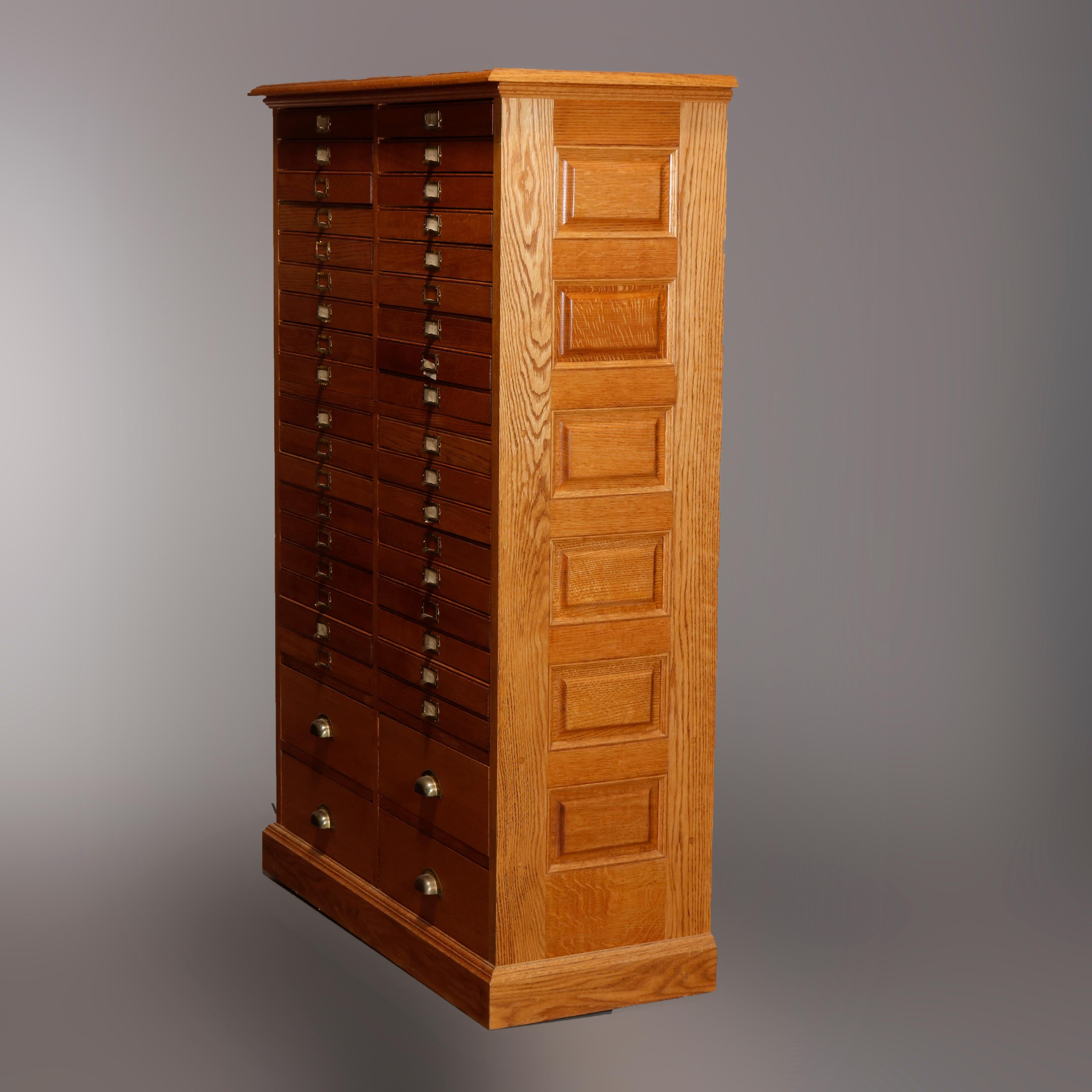 An antique print or map cabinet offers raised panel oak construction with 40 drawers, 20th century

Measures- 58.5