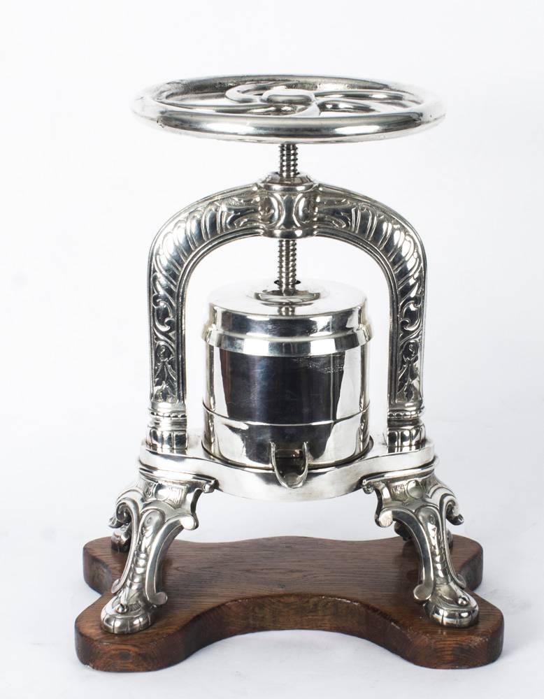 This is a fine substantial antique French silver and nickel-plated Duck Press, late 19th century in date.

The duck press stands on four substantial legs with embossed and engraved decoration and is mounted on a shaped solid oak base. It is fitted