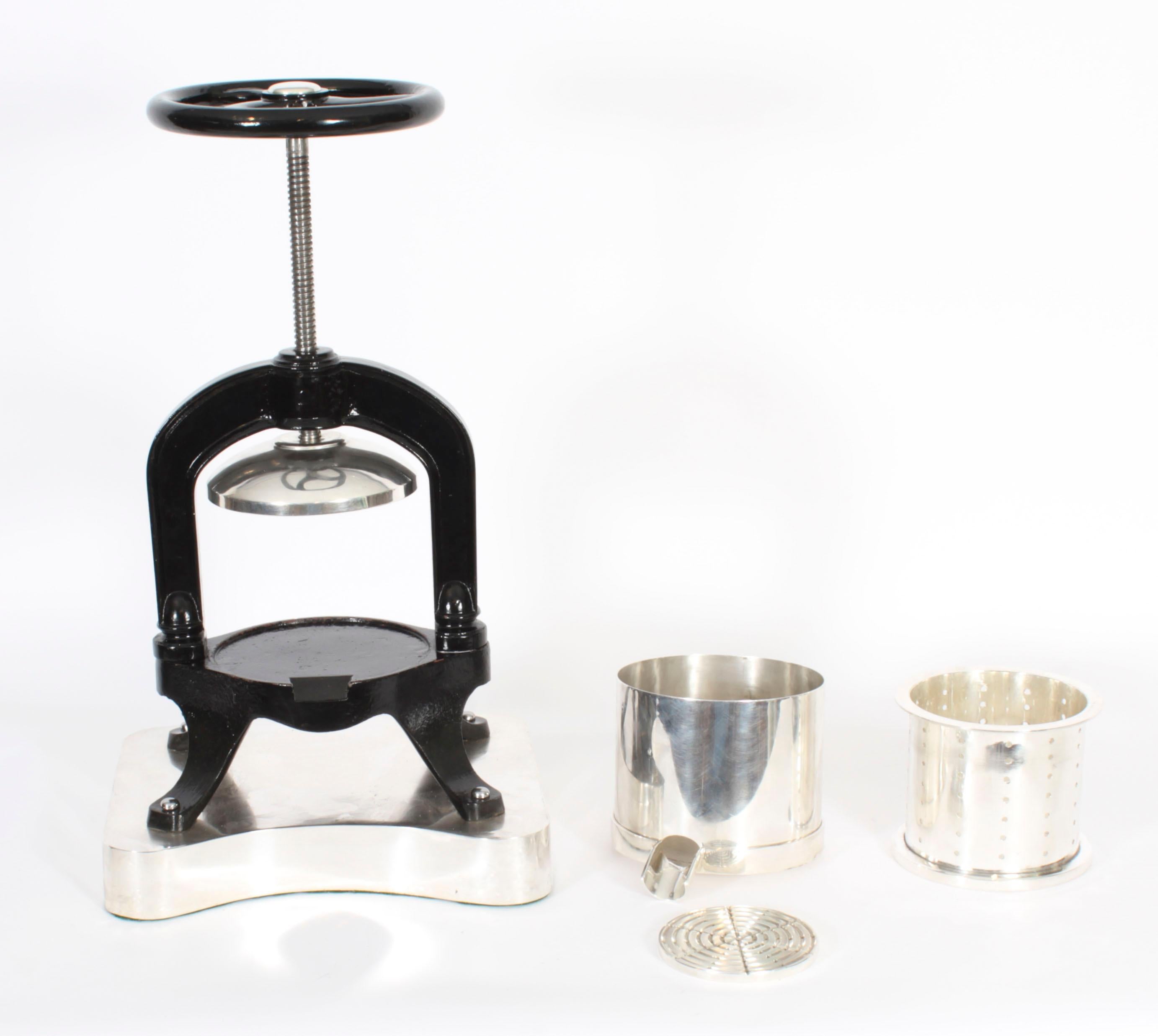 This is a fine substantial antique French silver plated and cast iron Duck Press, Circa 1920 in date.
  
The duck press stands on four substantial legs  and is mounted on a shaped silver plated platform base. It is fitted with a removable pot that